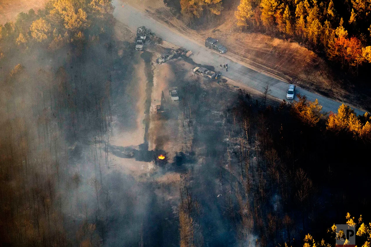 A flame continues to burn after a Monday explosion of a Colonial Pipeline, Tuesday, Nov. 1, 2016, in Helena, Ala. The blast, which sent flames and thick black smoke soaring over the forest, happened about a mile west of where the pipeline ruptured in September, Gov. Robert Bentley said in a statement. (AP Photo/Brynn Anderson)