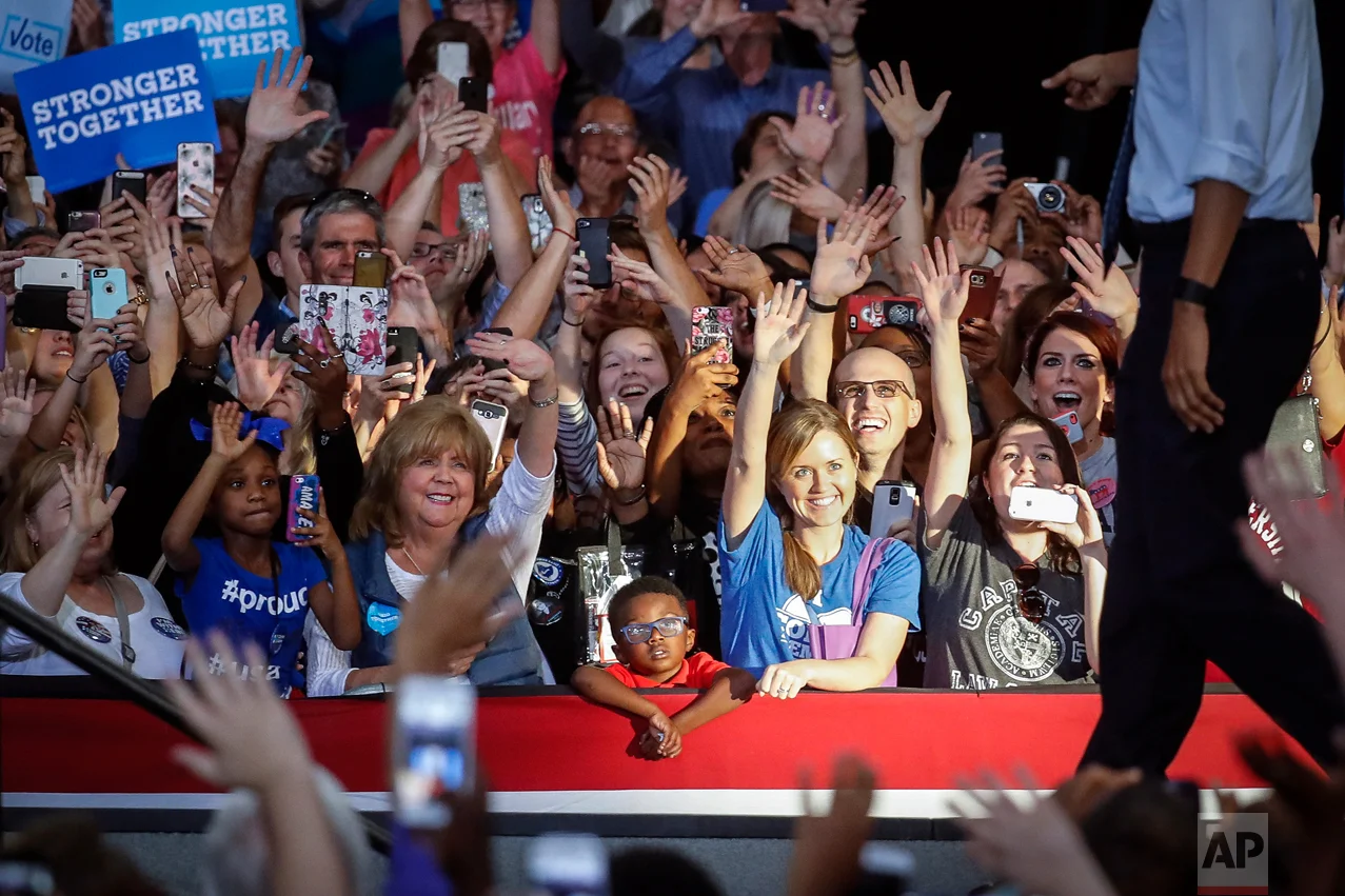 Attendees cheer as President Barack Obama, right, walks towards the podium during a campaign event for Democratic presidential candidate Hillary Clinton at Capital University, Tuesday, Nov. 1, 2016, in Columbus, Ohio. (AP Photo/John Minchillo)