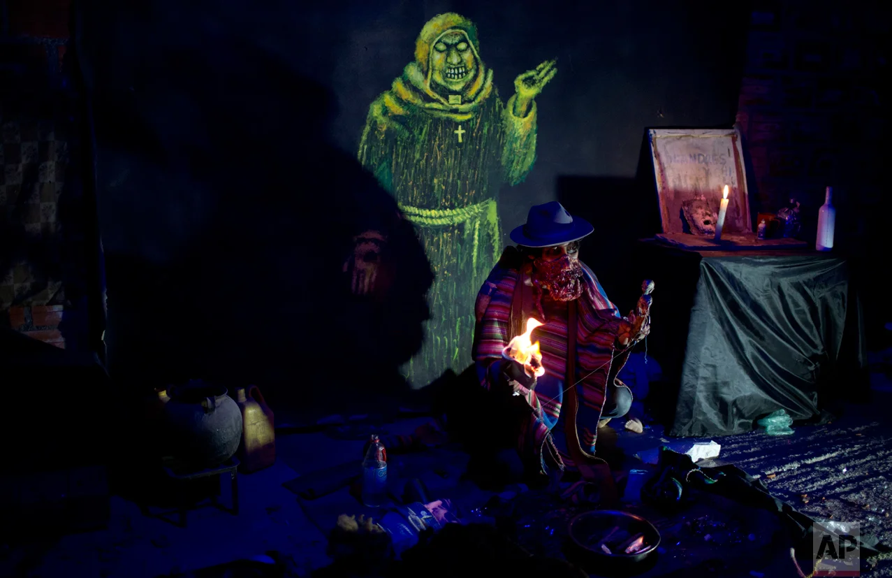 A man dressed as "kari kari" performs at a House of Terror during the celebration of All Saints in El Alto, Bolivia, Tuesday, Nov. 1, 2016. Bolivians from La Paz and El Alto, mostly of Aymara descent, have started to embraced Halloween celebrations introducing characters adapted from their own culture such as the "kari kari" a mythical creature that sucks the fat out of its victims and then makes them ill. (AP Photo/Juan Karita)