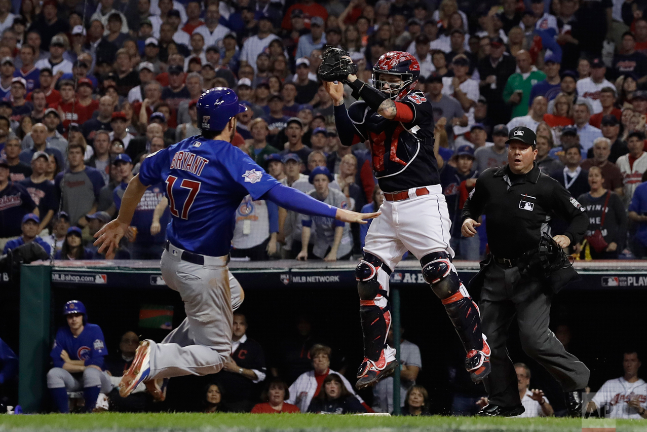  Chicago Cubs' Kris Bryant is safe at home as Cleveland Indians catcher Roberto Perez puts on a late tag during the fourth inning of Game 7 of the Major League Baseball World Series Wednesday, Nov. 2, 2016, in Cleveland. (AP Photo/Matt Slocum) 