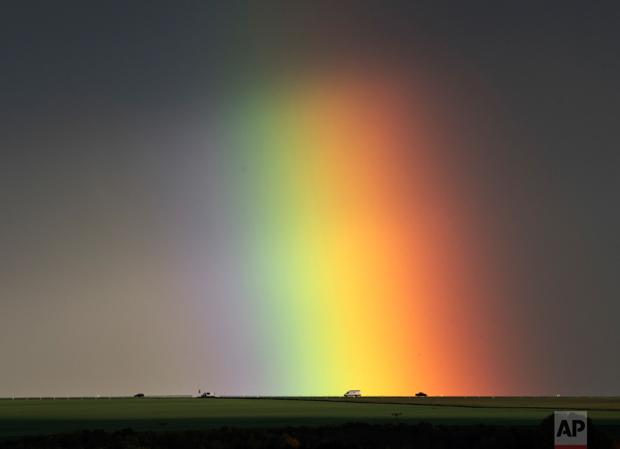  Cars drive under a rainbow near Bad Langensalza, Germany, Wednesday, Nov. 2, 2016. (AP Photo/Jens Meyer) 