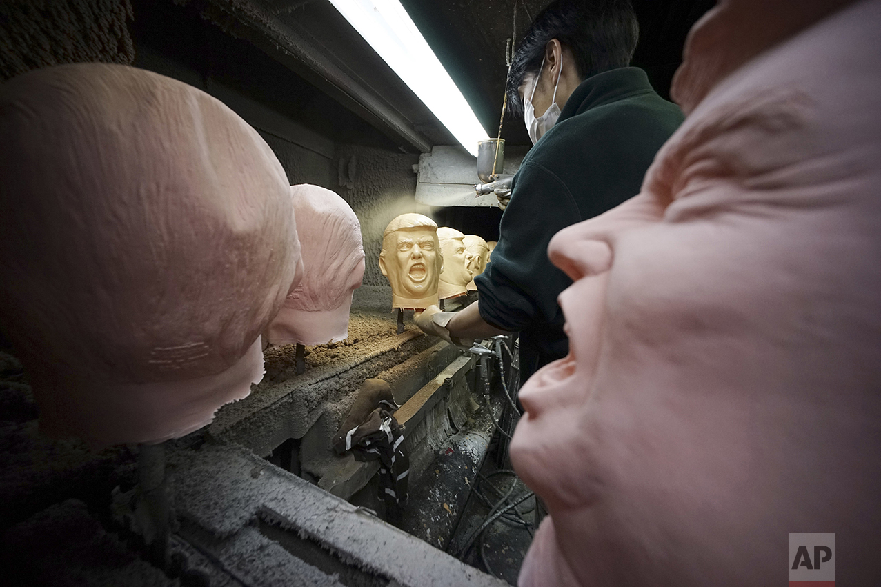  A worker spray paints rubber masks depicting President-elect Donald Trump on a production line at the Ogawa Studio in Saitama, north of Tokyo, Tuesday, Nov. 15, 2016. Ogawa Studio, the only manufacturer of rubber masks in Japan, is working non-stop 