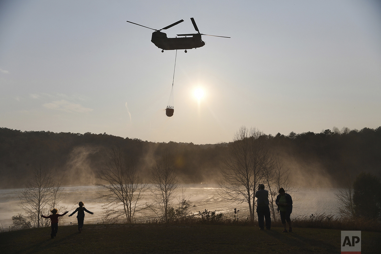  A Chinook helicopter pulls water out of Lake Oolenoy near Table Rock State Park in S.C., as firefighters continue to battle wildfires on Tuesday, Nov. 15, 2016. Dozens of wildfires have burned hundreds of square miles across the Southeast of the U.S