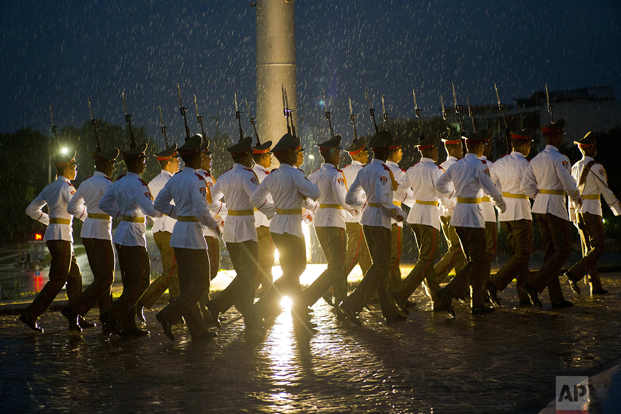 A Cuban honor guard marches through the rain after taking part in a ceremony for Canada's Prime Minister Justin Trudeau, at Revolution Square in Havana, Cuba, Tuesday, Nov. 15, 2016. (AP Photo/Ramon Espinosa)
