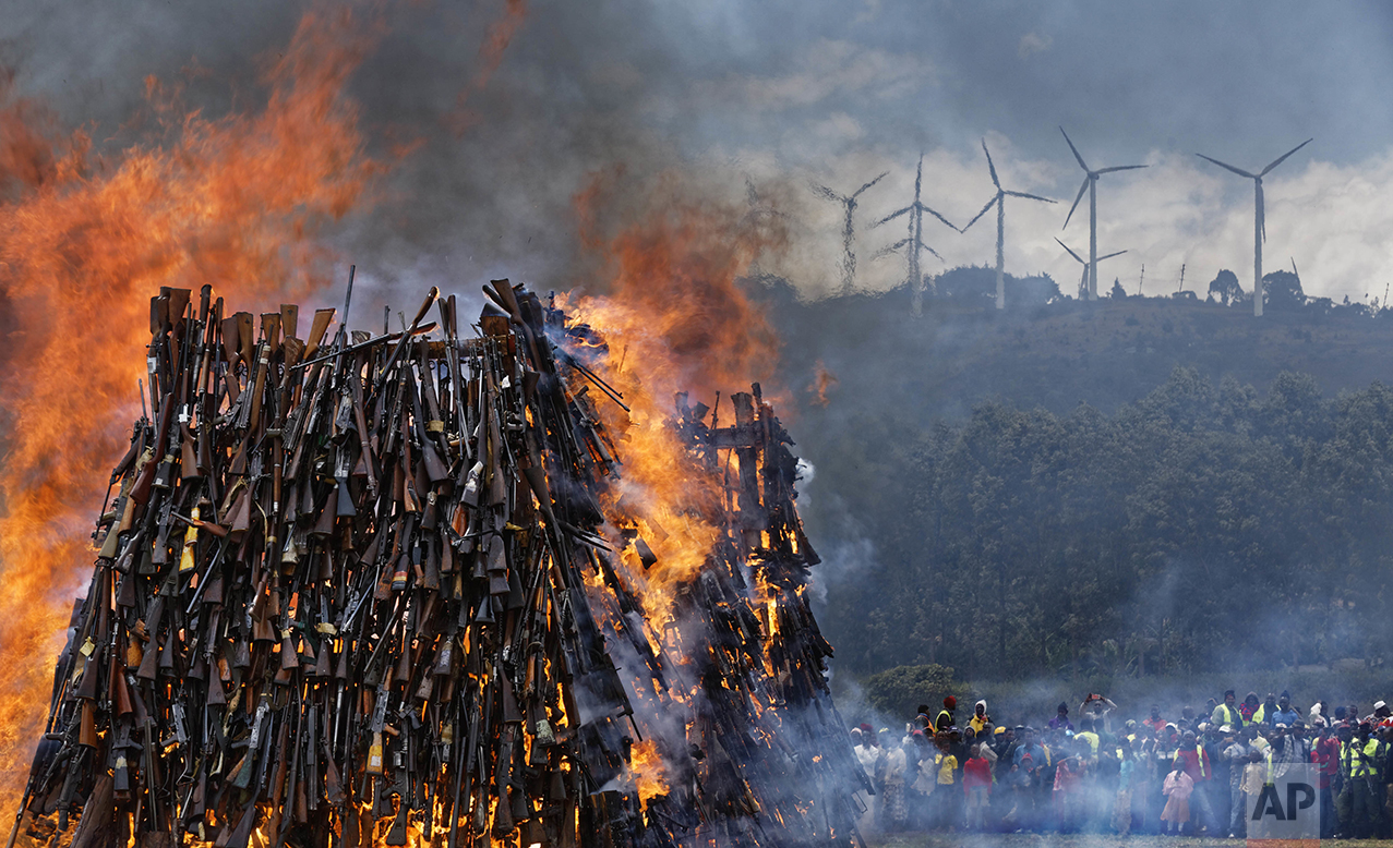  A pile of over 5,000 illegal weapons are burned by Kenyan police in Ngong, near Nairobi, in Kenya Tuesday, Nov. 15, 2016. The weapons consisted of both confiscated and surrendered firearms that had been stockpiled over almost a decade and were destr