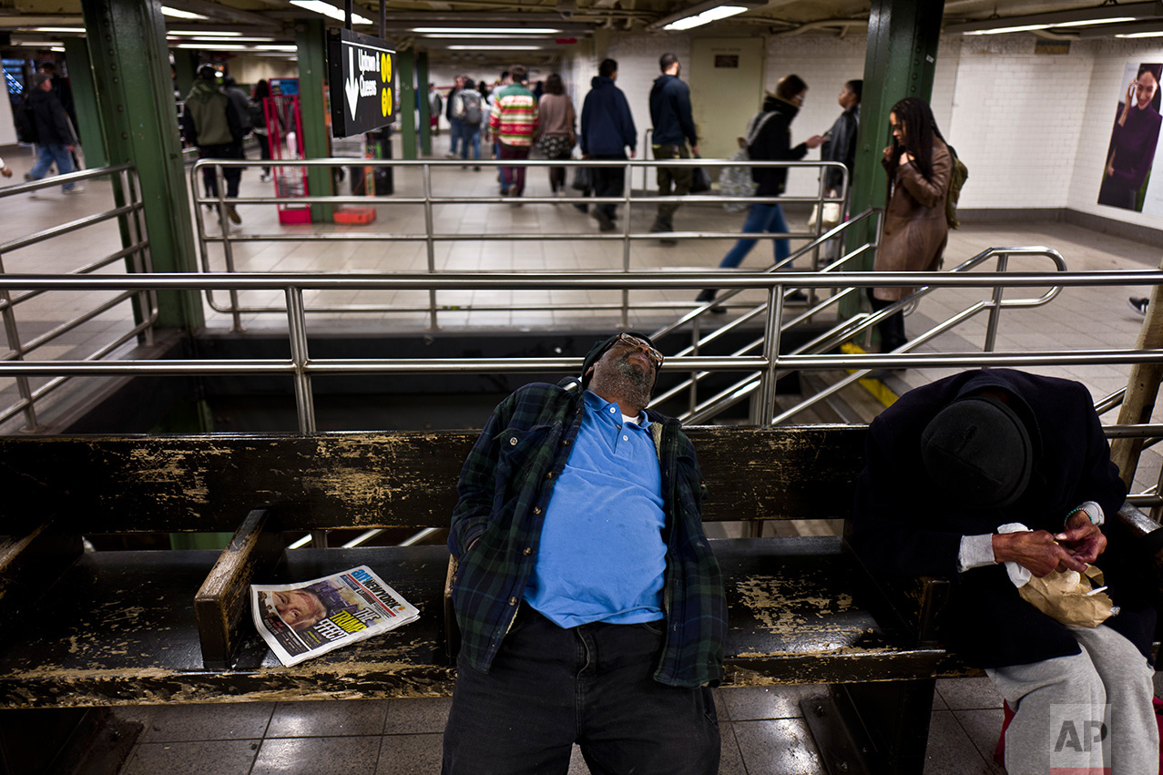 In this Monday, Nov. 14, 2016 photo, a newspaper featuring the image of President-elect Donald Trump on it's front page is left on a bench in a subway station in New York. (AP Photo/Muhammed Muheisen)