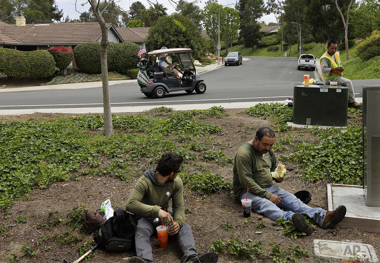 Duncan Wallace drives a golf cart from his house to his golf club as a group of landscape workers take a break in Vista, Calif., on Wednesday, May 4, 2016. Wallace, who owns a medical supplies company, said he's been a conservative for 50 years, ever since he read Barry Goldwater's book, "Conscience of a Conservative." "I think we punish success, actually," he says. "I know a lot of people who are quite successful, and they are paying an awful lot of money in taxes. They are paying for people who don"t have their oar in the water." (AP Photo/Gregory Bull)