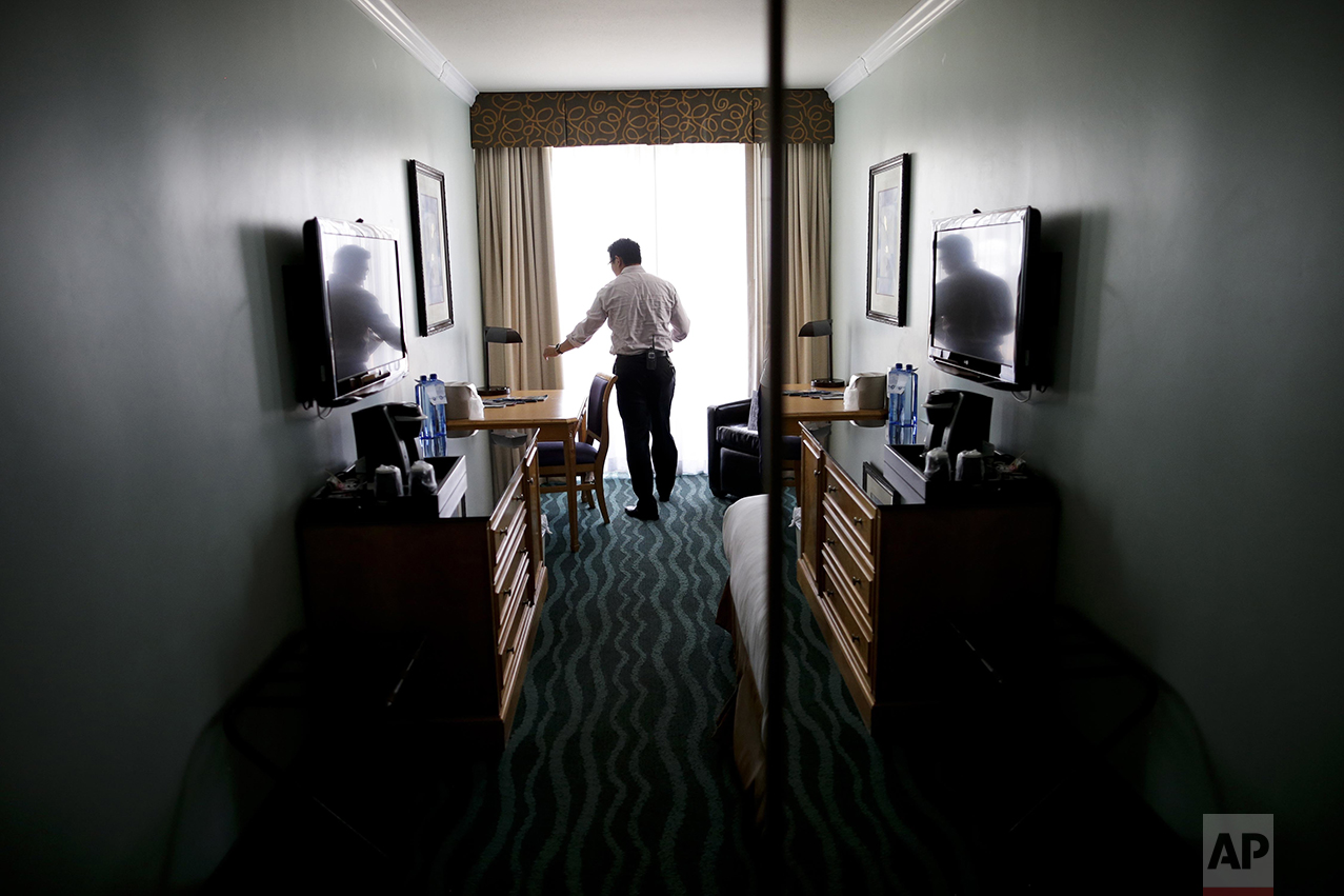 Hotel owner Elvin Lai inspects a room as he makes his rounds at his hotel in San Diego on Friday, June 10, 2016. A fourth-generation hotelier, Lai has worked his way through nearly every job at the small beach hotel. "Raising the minimum wage doesn't necessarily raise their ability to live," he said. "It is uplifting them through certain skills and increasing their ability to earn while keeping minimum wage at a low. What does a minimum wage increase do? It raises everything. As minimum wage is going up, everything goes up. I'll have to raise my food prices on a week to week basis, as my vendors, and their vendors, increase their prices." (AP Photo/Gregory Bull)