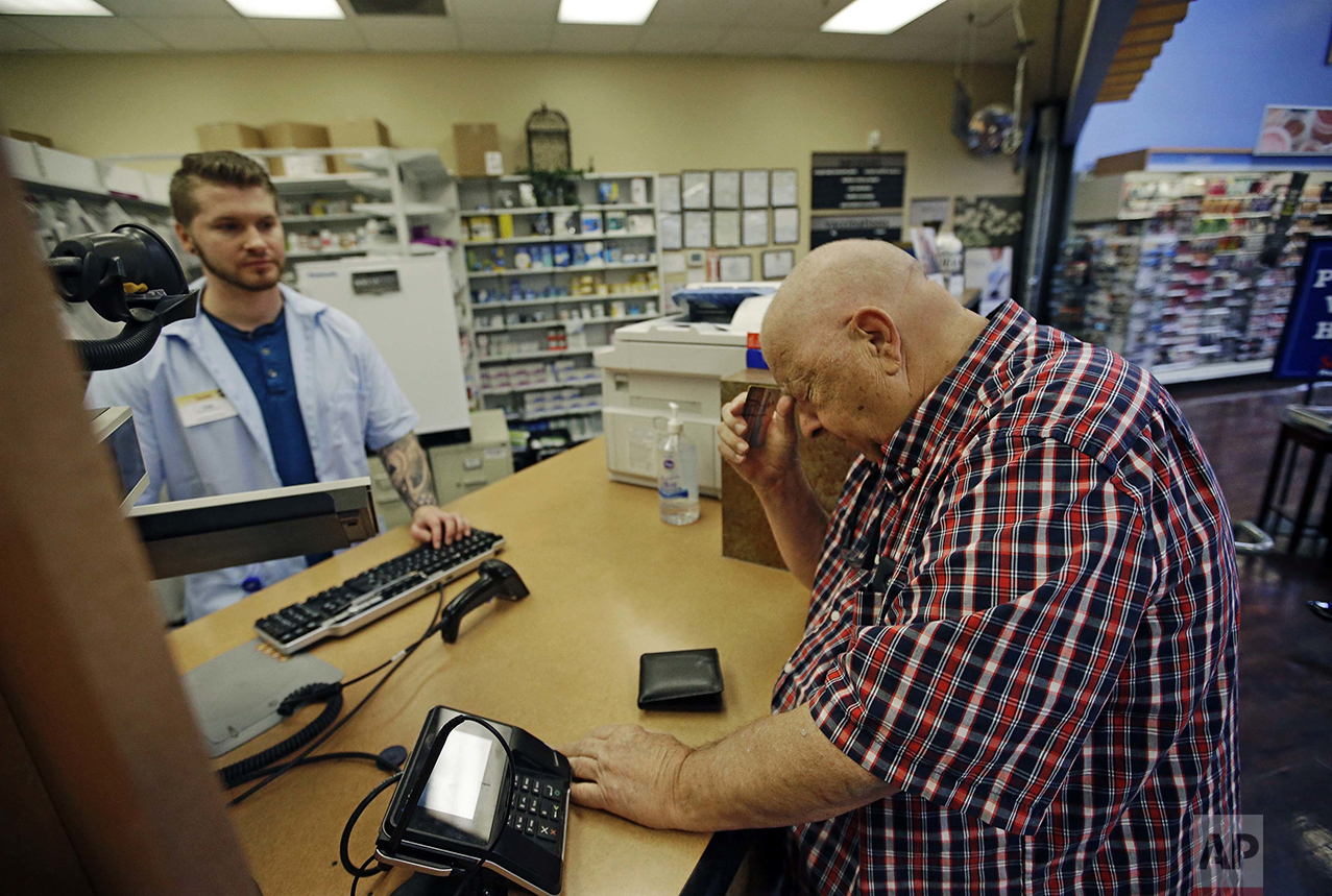 Uber driver Russ Schmidt, 74, picks up his wife's prescription drugs from Smiths Pharmacy in Salt Lake City on Thursday, June 2, 2016. Schmidt, who retired 10 years earlier, said he became an Uber driver after his wife's fall 2015 hospitalization and uses the money to help pay for her medication. "I'm a fanatical fan of this country. I think it's the best country in the world and always has been," he says. "I think we're in real trouble right now. I have worked, and I still continue at 75 to work my butt off to make a good life for my family. And now that it is almost being stolen from me." (AP Photo/Rick Bowmer)