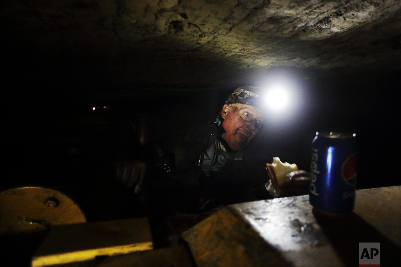Coal miner Scott Tiller eats a sandwich during his lunch break in a mine less than 40-inches high in Welch, W.Va. For over a century, life in Central Appalachia has been largely defined by the ups and downs of the coal industry. There is a growing sense in these mountains that for a variety of reasons - economic, environmental, political - coal mining will not rebound this time. The slump is largely the result of cheap natural gas, and older coal-fired power plants being idled to meet clean-air standards. According to the Labor Department, there were 56,700 jobs in coal mining in March, down from 84,600 in March 2009, shortly after President Barack Obama entered office. "I have four grandchildren who are going to have to have some kind of a future," said Tiller. "I don't want them being coal miners. It's a hard, tough way to make it and I just don't want that for them." (AP Photo/David Goldman)