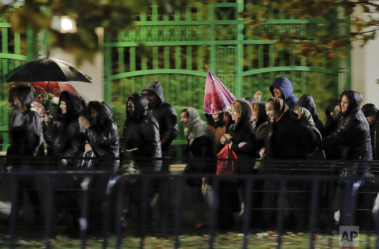  In this Wednesday, Oct. 26, 2016 picture, Orthodox worshippers cheer as they are allowed to advance in the line for touching the remains of Saint Dimitrie Bassarabov in Bucharest, Romania. The Romanian Orthodox and Catholic churches staged pilgrimag