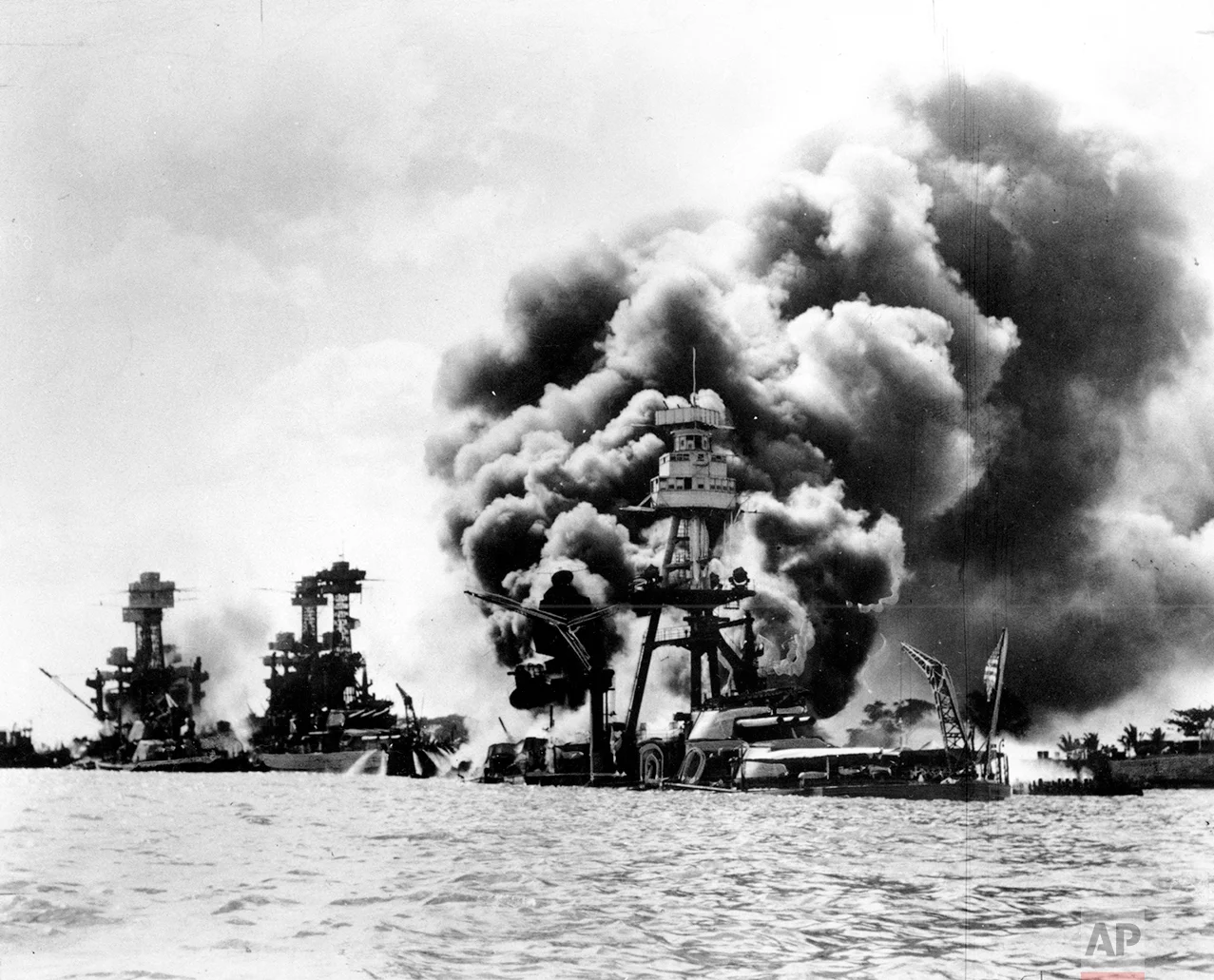 Three U.S. battleships are hit from the air during the Japanese attack on Pearl Harbor on Dec. 7, 1941. Japan's bombing of U.S. military bases at Pearl Harbor brings the U.S. into World War II. From left are: USS West Virginia, severely damaged; USS Tennessee, damaged; and USS Arizona, sunk. (AP Photo)