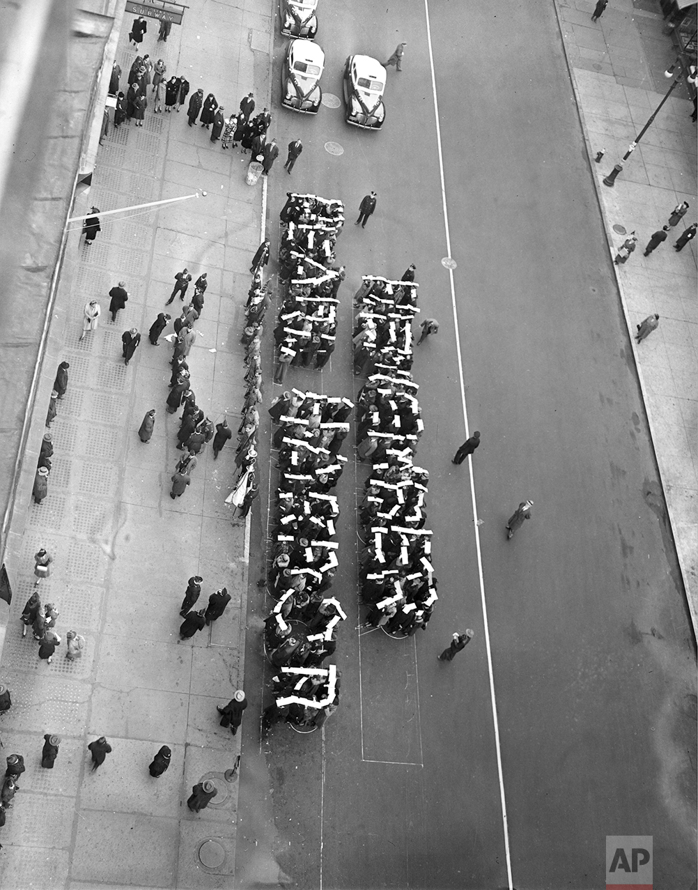Members of the Hearns Volunteer National Defense Corps spell the slogan "Remember Pearl Harbor" at a rally held on 14th St. between Fifth and Sixth Avenues in New York City, Dec. 27, 1941. (AP Photo)