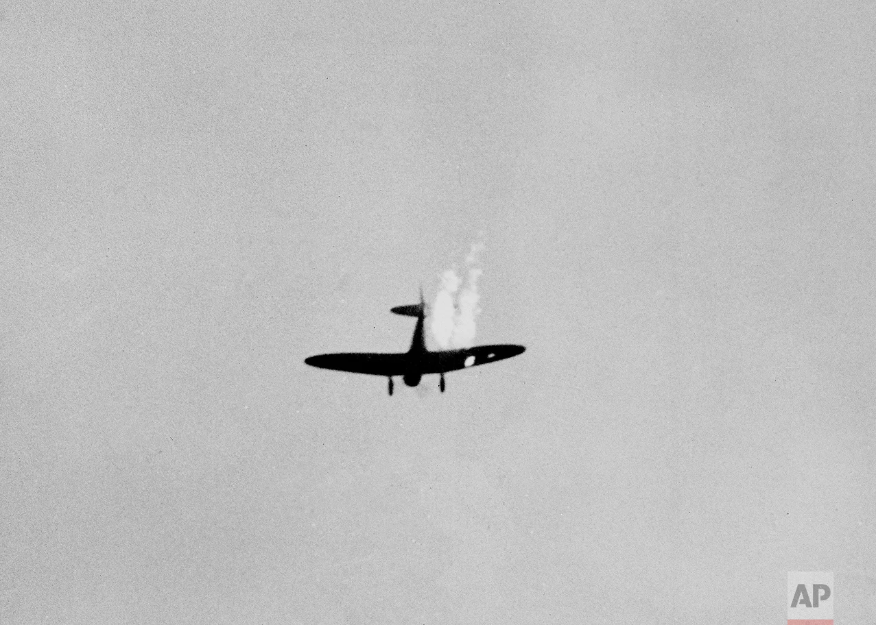 A Japanese dive bomber goes into its last dive as it heads toward the ground in flames after it was hit by Naval anti-aircraft fire during surprise attack on Pearl Harbor, Dec. 7, 1941. (AP Photo)
