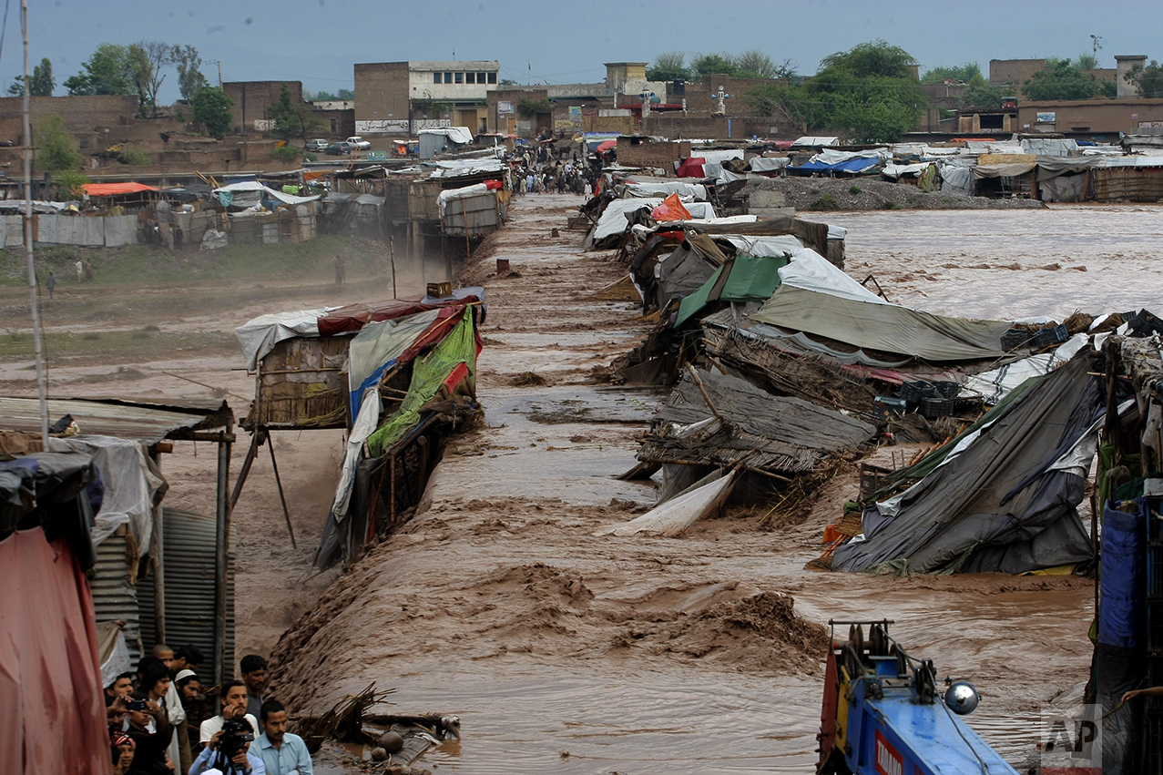  Villagers stand outside their homes during flash floods on the outskirts of Peshawar, Pakistan, on April 3, 2016. (AP Photo/Mohammad Sajjad) 