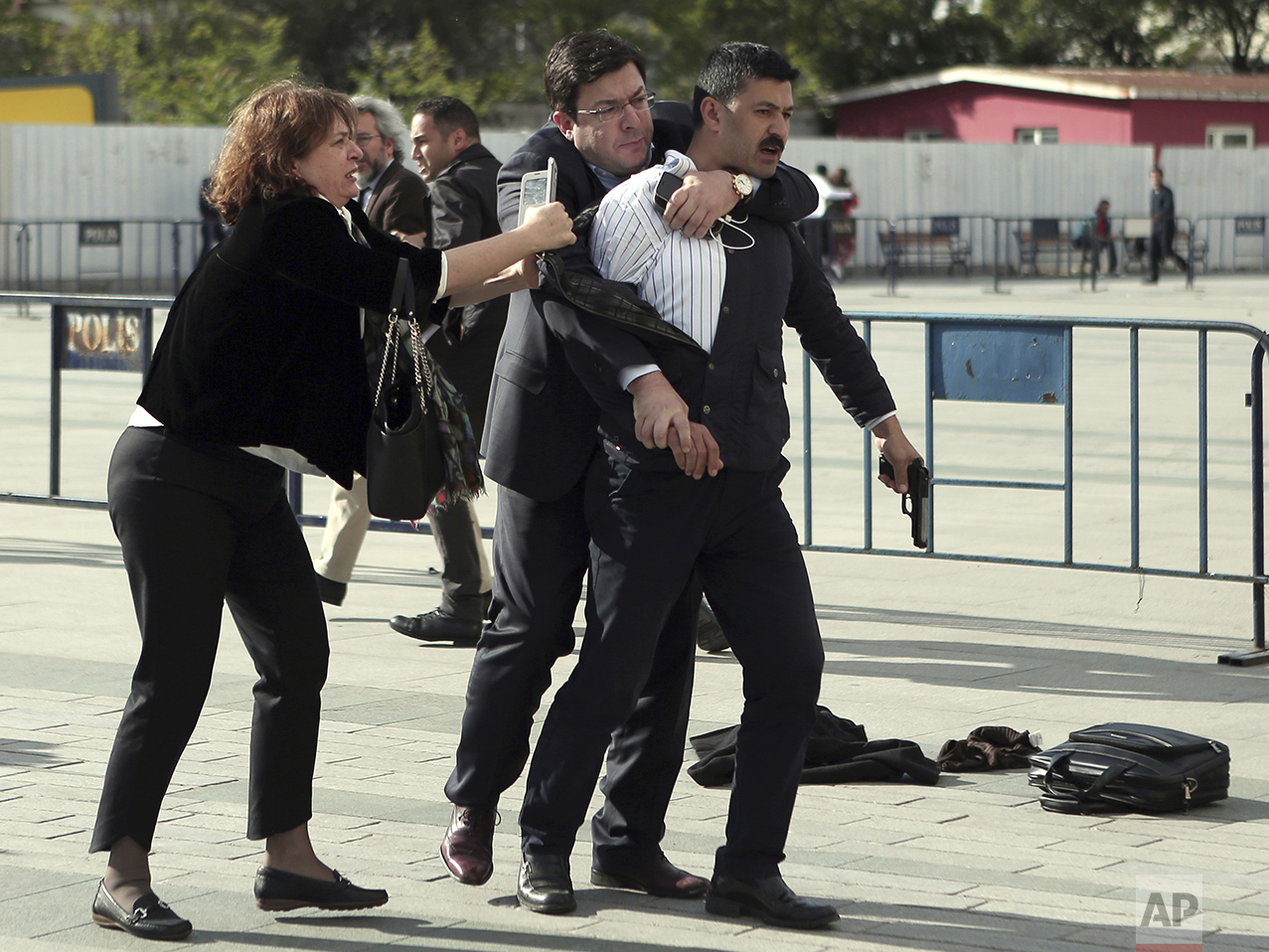  Dilek Dundar, wife of journalist Can Dundar, and his lawyer, second left, overpower a gunman just after he attacked Can Dundar outside Istanbul's main courthouse on May 6, 2016. The man shouted "traitor" and fired two shots at Dundar, who was on tri