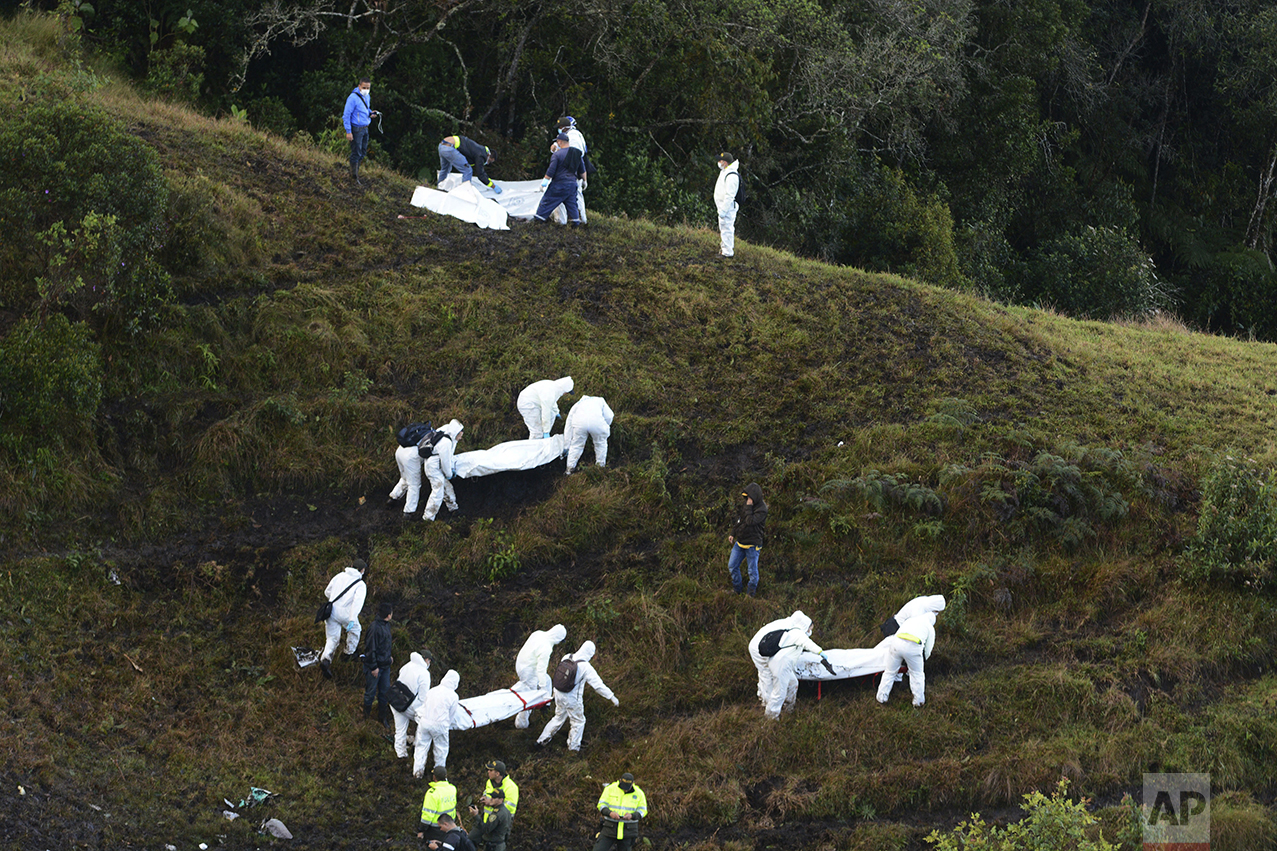  Rescue workers carry the bodies of victims of an airplane crash in a mountainous area near La Union, Colombia, on Nov. 29, 2016. The plane was carrying the Brazilian first division soccer club Chapecoense team, which was on its way for a Copa Sudame