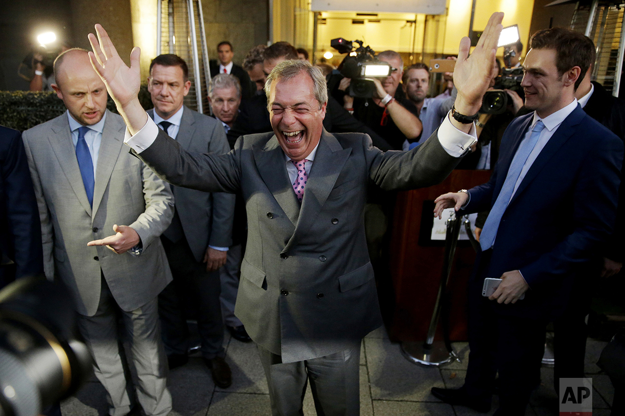  Nigel Farage, the leader of the UK Independence Party, celebrates and poses for photographers as he leaves a "Leave.EU" organization party for the British European Union membership referendum in London on June 24, 2016. (AP Photo/Matt Dunham) 