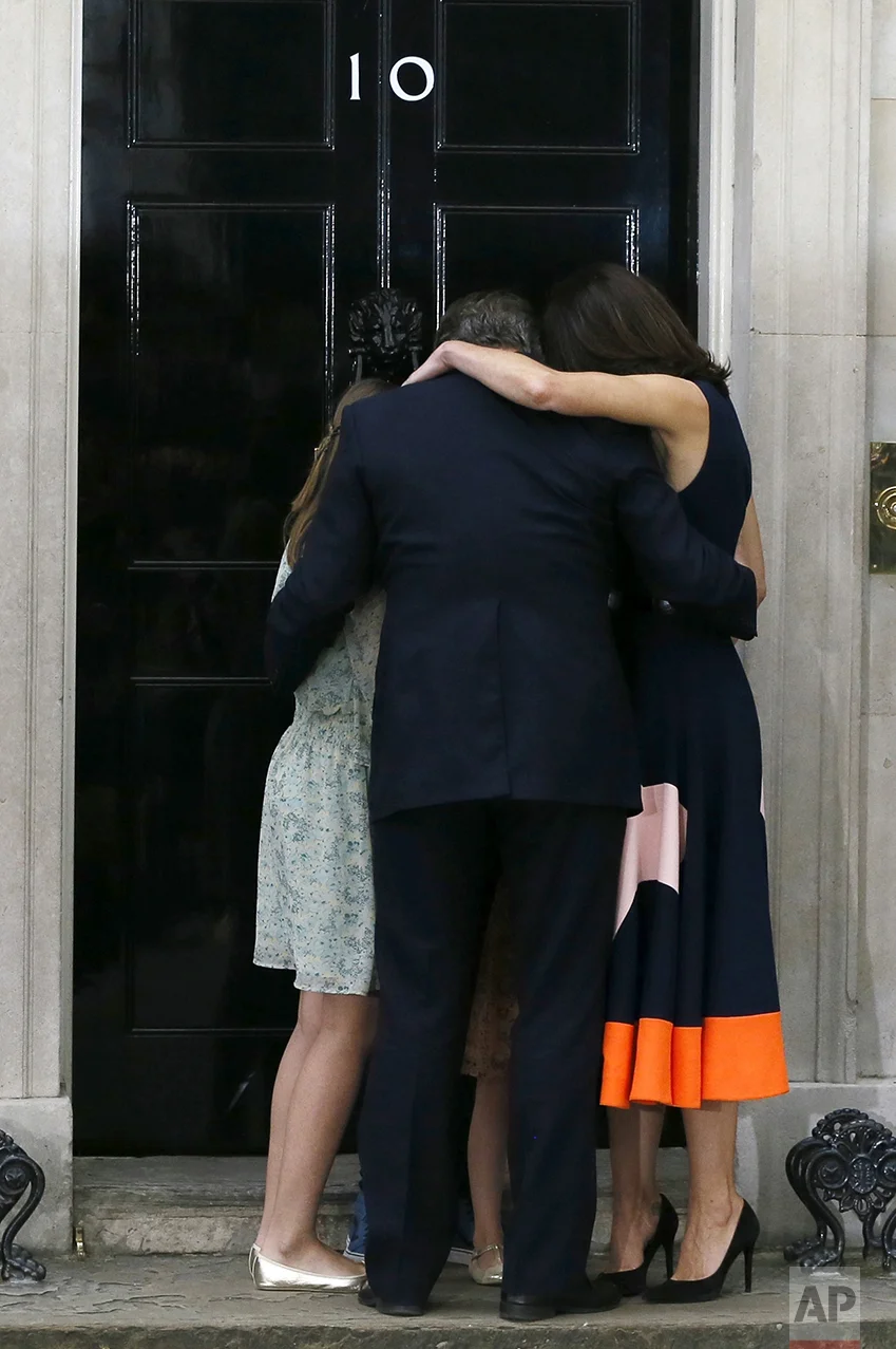 Britain's Prime Minister David Cameron, his wife Samantha and their children Nancy, Elwen and Florence, hug on the steps of 10 Downing Street in London on July 13, 2016. Cameron stepped down after six years as prime minister. (AP Photo/Kirsty Wigglesworth)