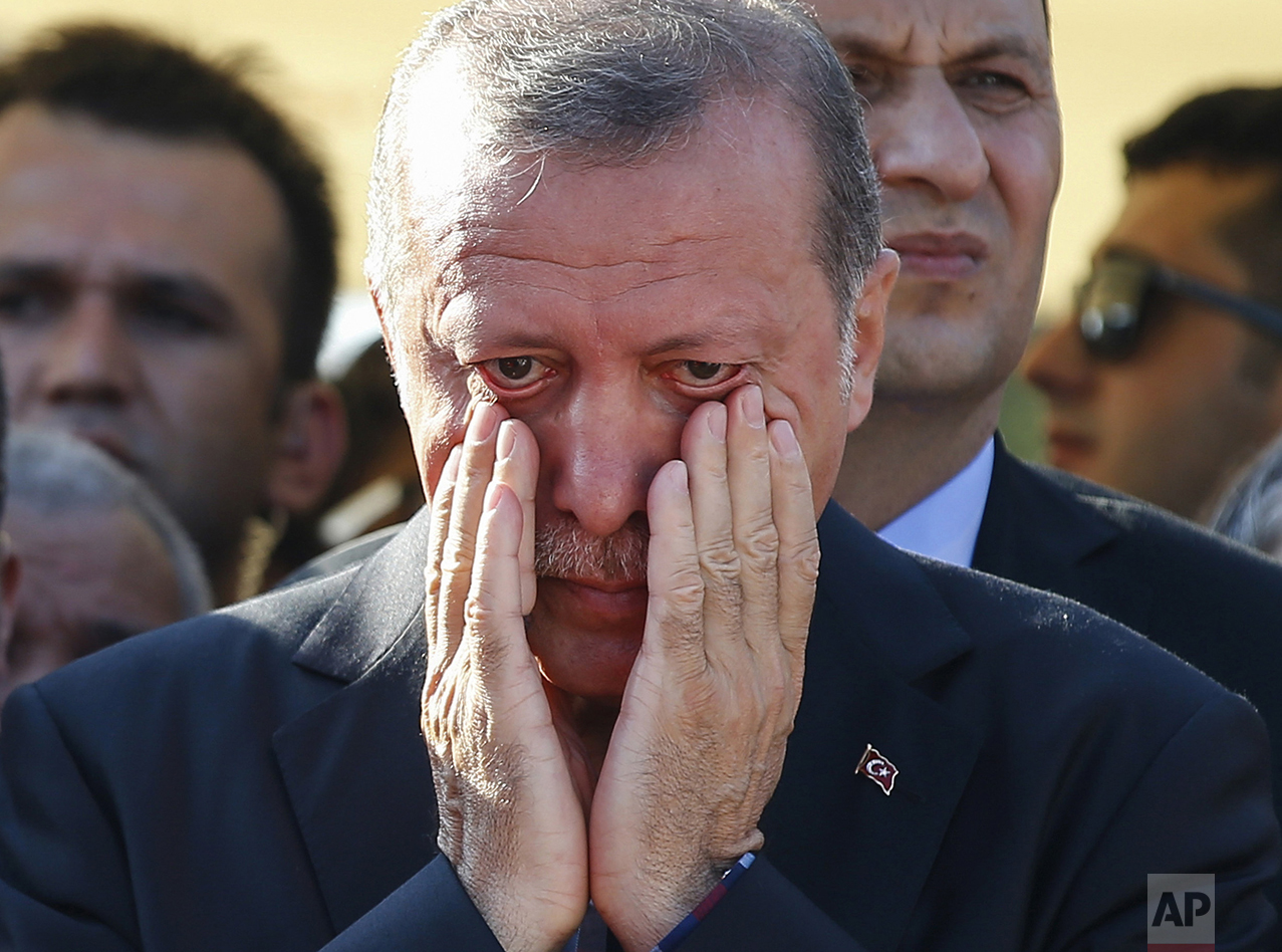  Turkish President Recep Tayyip Erdogan, right, wipes his tears during the funeral of Mustafa Cambaz, Erol and Abdullah Olcak, killed while protesting the attempted coup against Turkey's government, in Istanbul on July 17, 2016. (AP Photo/Emrah Gurel