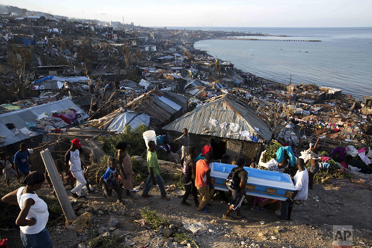  Residents carry a coffin containing the remains of a pregnant woman, a victim of Hurricane Matthew, in Jeremie, Haiti, on Oct. 7, 2016. (AP Photo/Dieu Nalio Chery) 