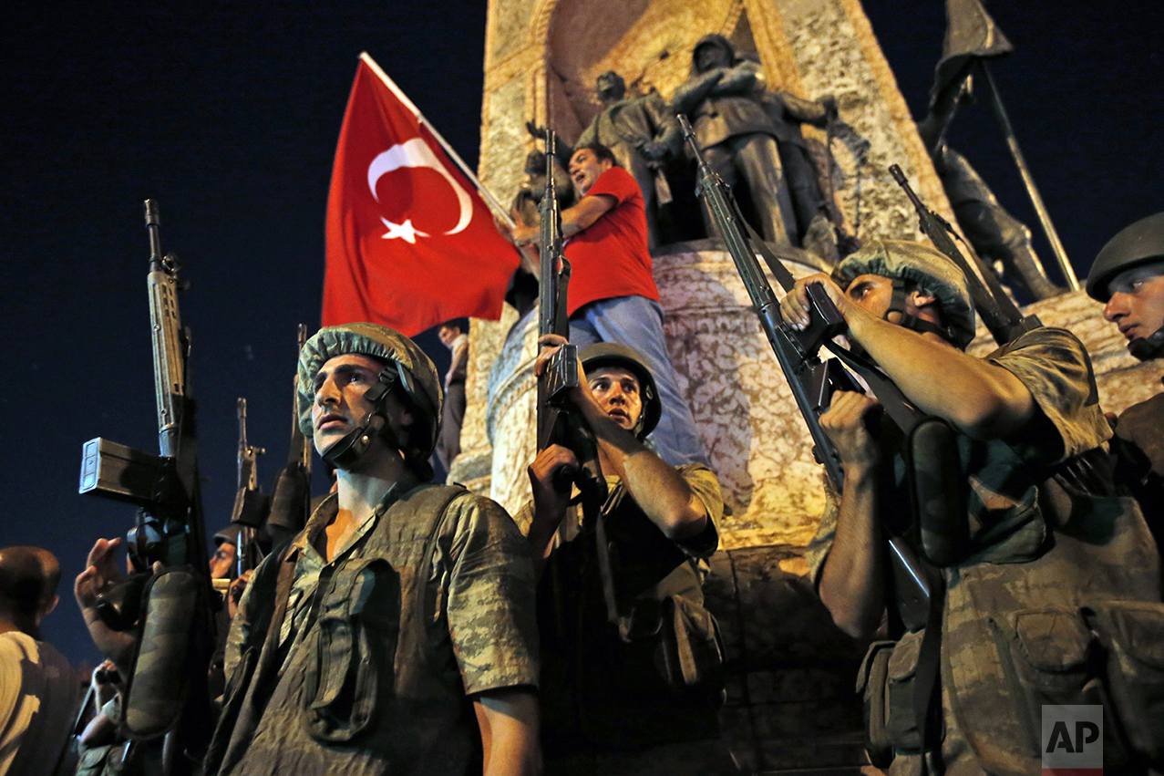  Turkish soldiers secure the area as supporters of Turkey's President Recep Tayyip Erdogan protest in Istanbul's Taksim square on July 16, 2016. Prime Minister Binali Yildirim said a group within Turkey's military had engaged in what appeared to be a