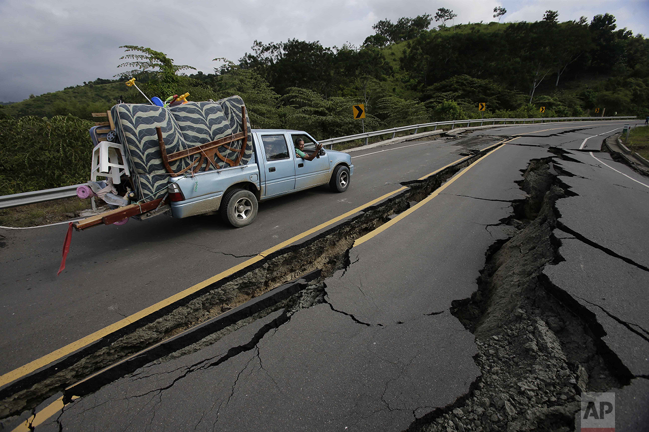  A truck moves the belongings of a family over a road destroyed by an earthquake from Pedernales to Jama, Ecuador, on April 18, 2016. The earthquake left a trail of ruin along Ecuador's Pacific Ocean coast. Hundreds died, thousands were homeless and 