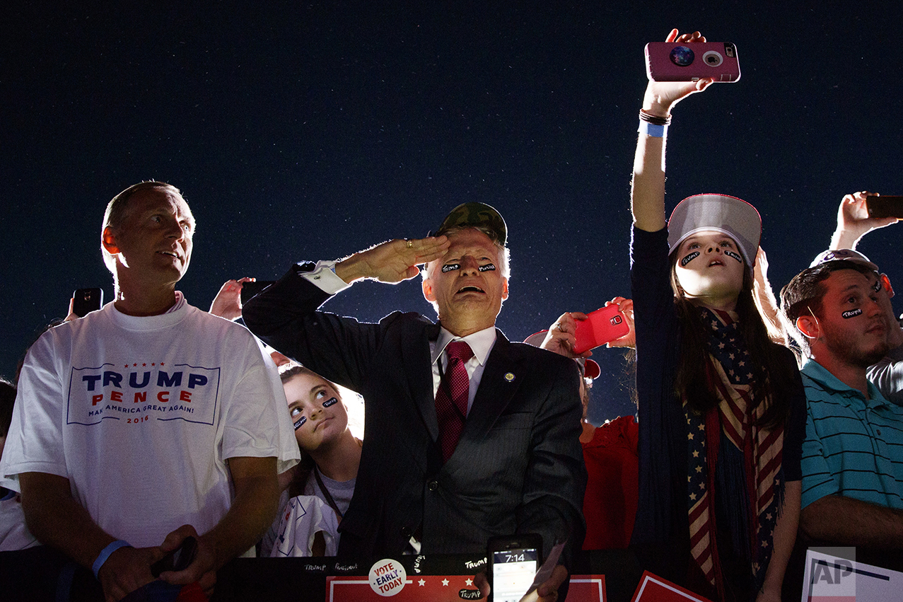  Jeff Muller of Wilmington, N.C., salutes as Republican presidential candidate Donald Trump arrives at a campaign rally on Oct. 26, 2016, in Kinston, N.C. (AP Photo/ Evan Vucci) 