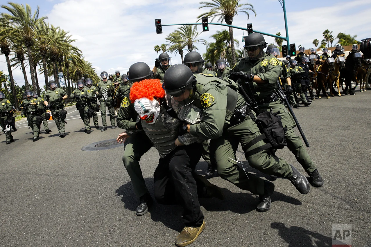 Orange County Sheriff's deputies take a protester into custody outside the Anaheim Convention Center where Republican presidential candidate Donald Trump is holding a rally, on May 25, 2016, in Anaheim, Calif. (AP Photo/Jae C. Hong)