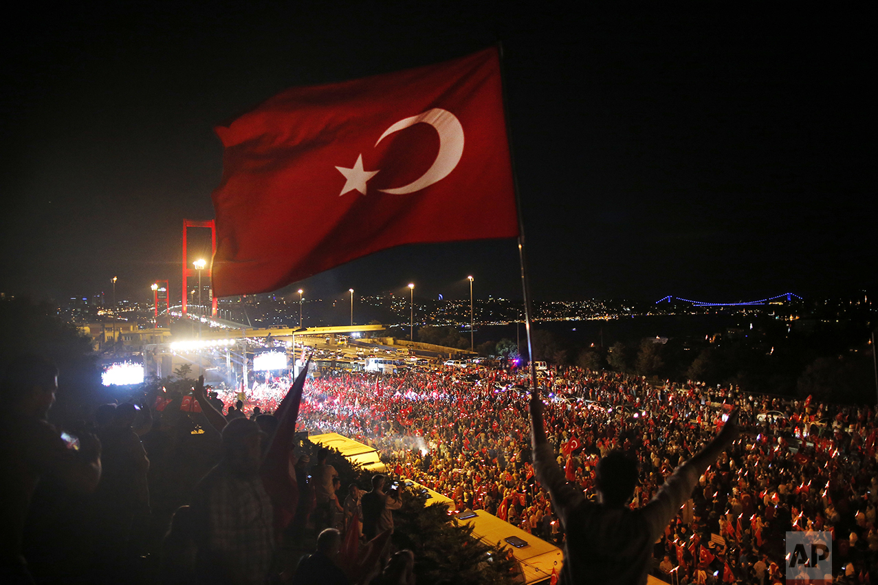  Pro-government supporters protest on the road leading to Istanbul's iconic Bosporus Bridge, background left, on July 21, 2016. Turkish lawmakers convened to endorse sweeping new powers for Turkey's President Recep Tayyip Erdogan that would allow him