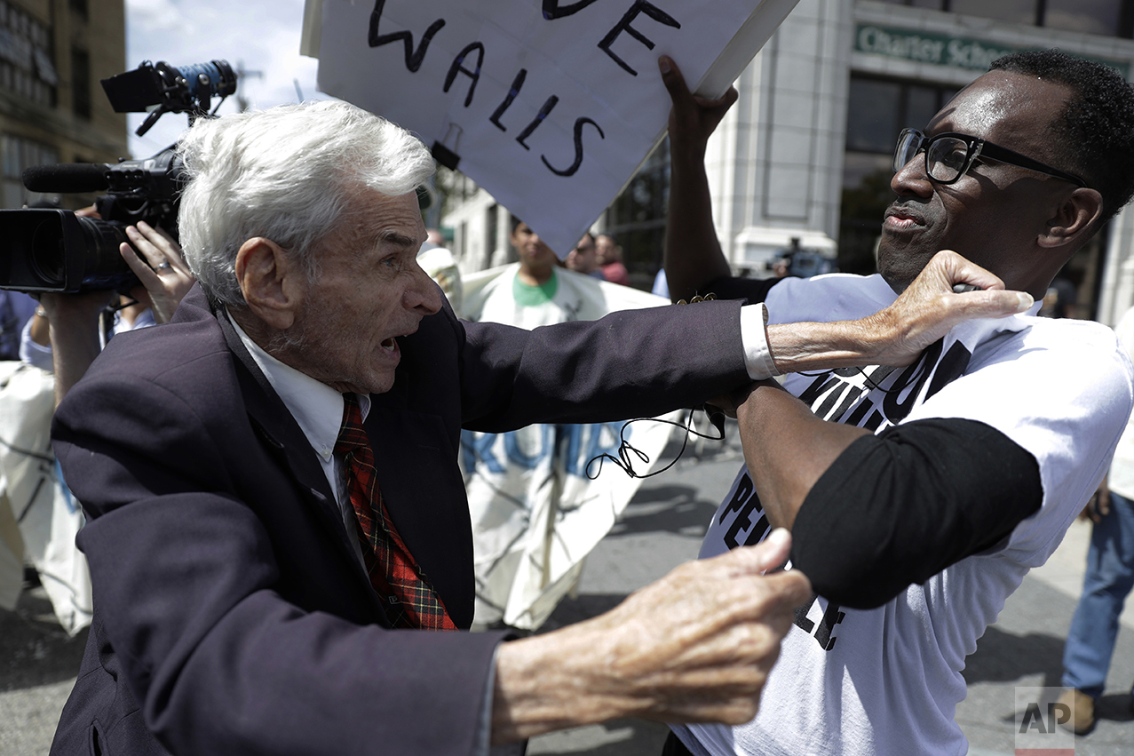  Jerry Lambert, left, a supporter of Republican presidential candidate Donald Trump, and Asa Khalif with Black Lives Matter scuffle after Khalif took Lambert's sign outside the location where Trump is to meet with African American business and civic 