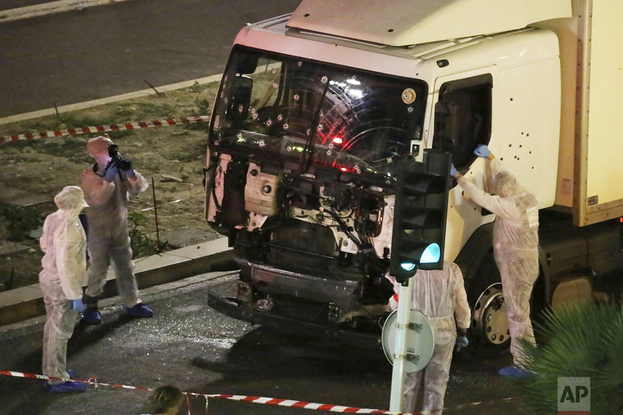  Authorities investigate a truck after it plowed through Bastille Day revelers in the French resort city of Nice, France, on July 14, 2016. France was ravaged by its third attack in two years when a large white truck mowed through revelers gathered f