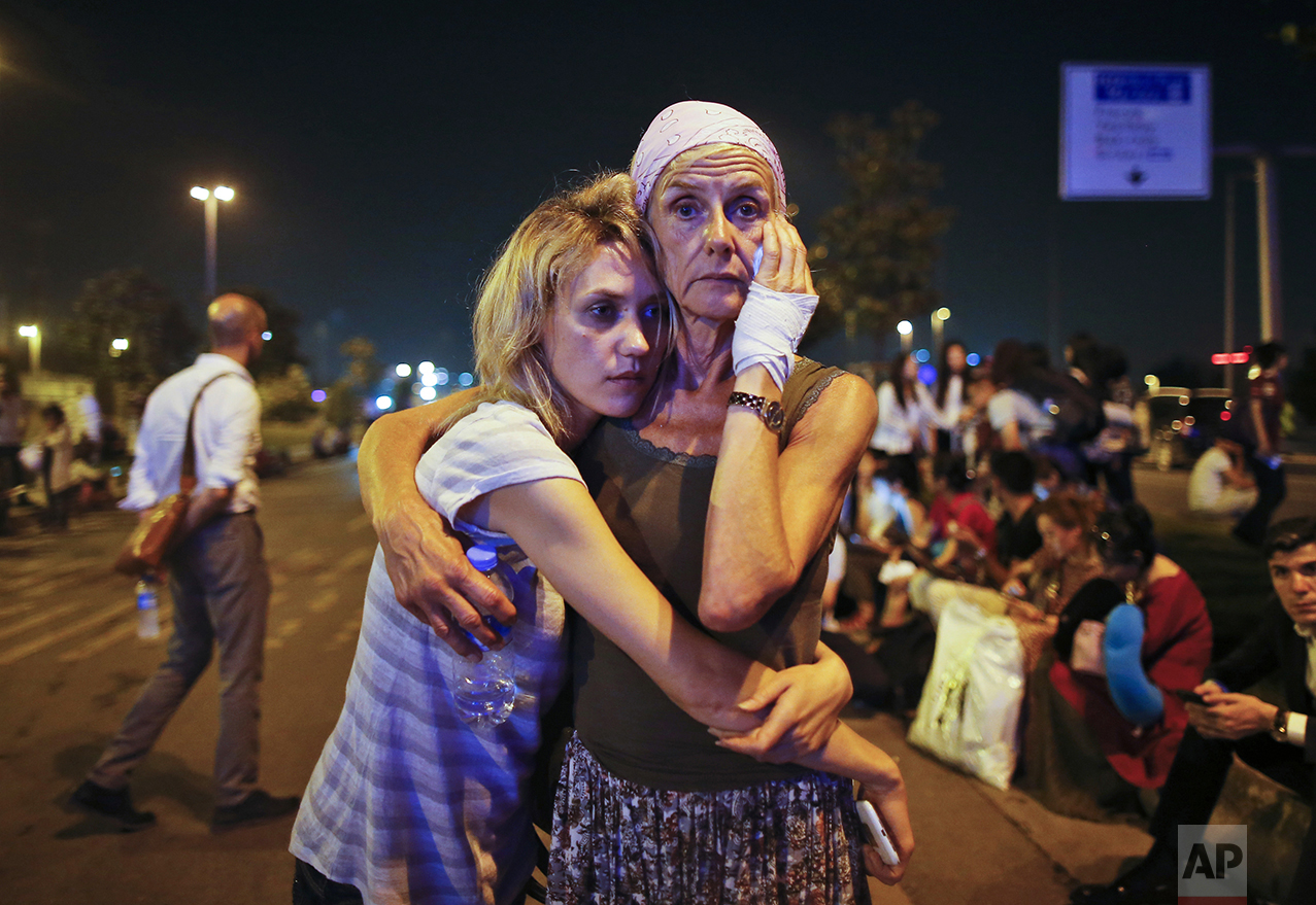  Passengers embrace each other as they wait outside Istanbul's Ataturk airport, on June 29, 2016, following their evacuation after a blast. Suspected Islamic State group extremists hit the international terminal of Istanbul's Ataturk airport, killing