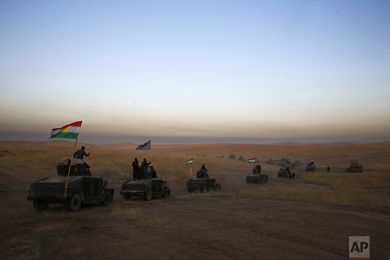  A Peshmerga convoy drives toward the frontline in Khazer, about 30 kilometers (19 miles) east of Mosul, Iraq, on Oct. 17, 2016. The Iraqi military and the country's Kurdish forces have launched operations to the south and east of militant-held Mosul