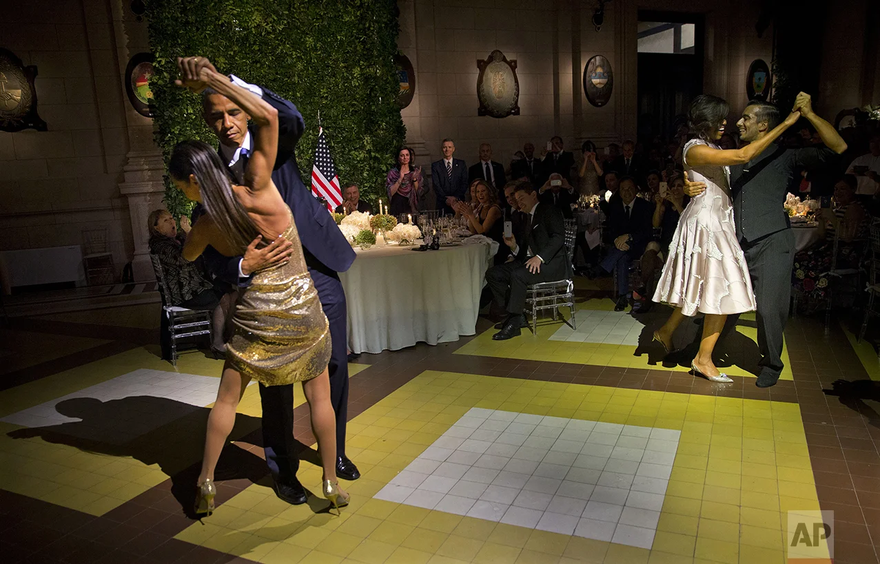 President Barack Obama and first lady Michelle Obama, right, dance the tango with tango dancers during the State Dinner at the Centro Cultural Kirchner in Buenos Aires, Argentina, on March 23, 2016. (AP Photo/Pablo Martinez Monsivais)