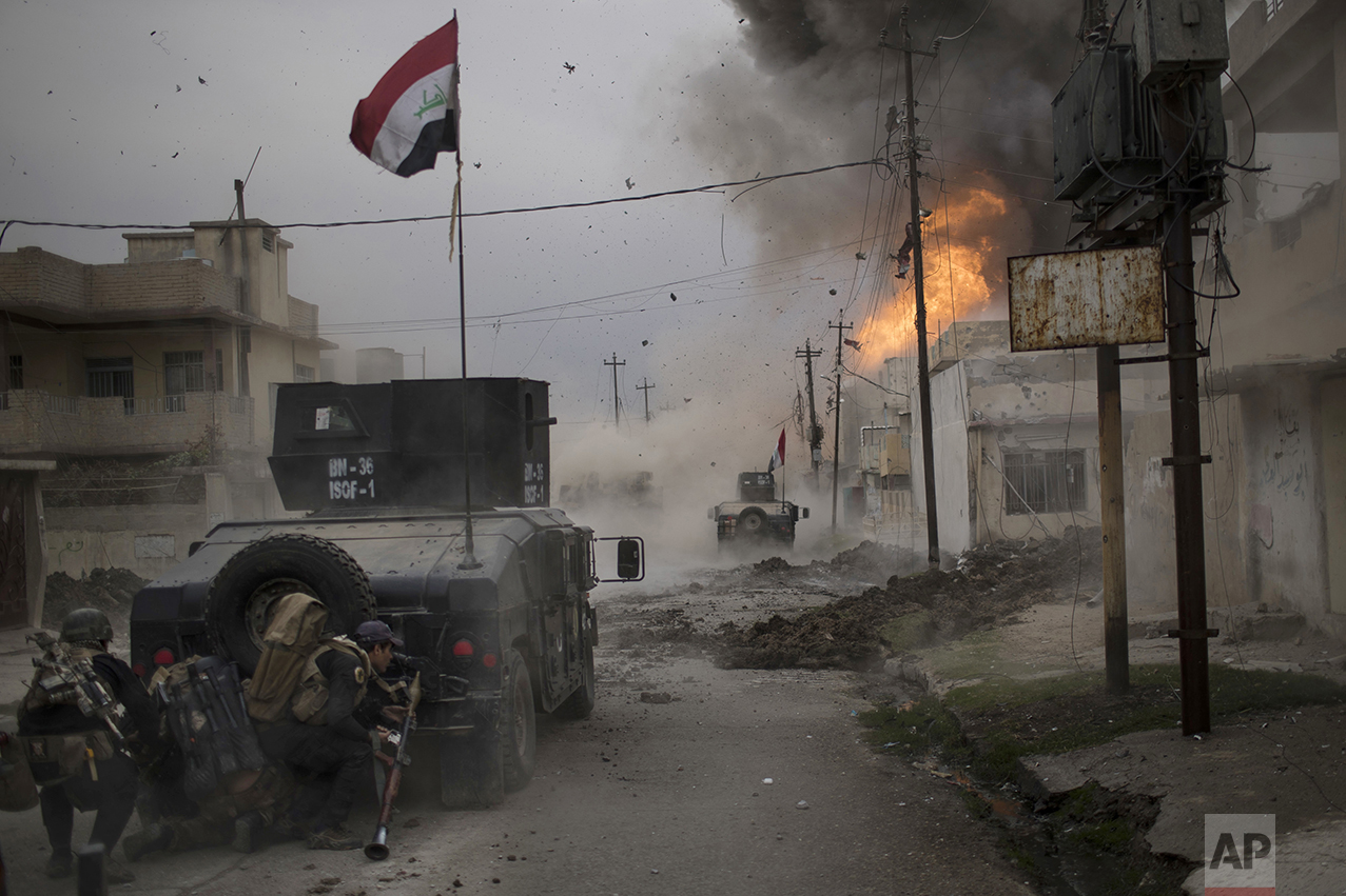  A car bomb explodes next to Iraqi special forces armored vehicles as they advance toward territory held by the Islamic State group in Mosul, Iraq, on Nov. 16, 2016. (AP Photo/Felipe Dana) 