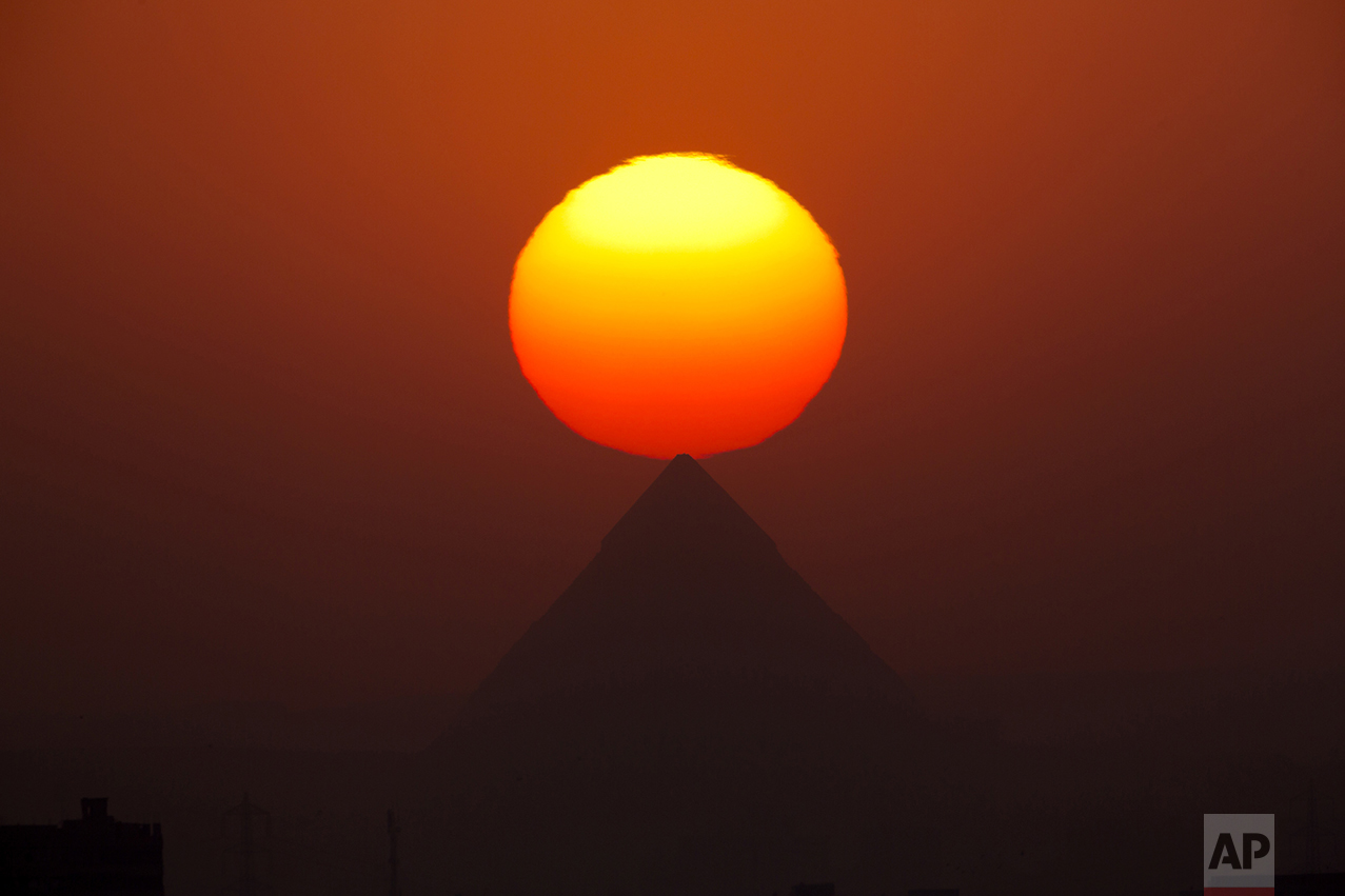 The sun sets over the the Giza Pyramids near Cairo, Egypt, on Aug. 19, 2016. (AP Photo/Amr Nabil)