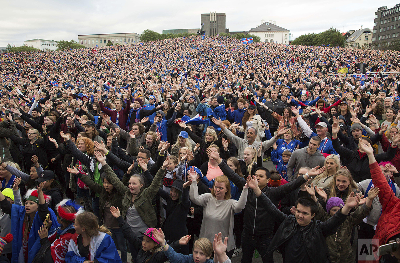  Icelandic soccer fans celebrate as they watch the Euro 2016 round of 16 match between Iceland and England shown on a screen in Reykjavik, Iceland, on June 27, 2016. Iceland pulled off the shock of the European Championship by beating England 2-1 in 