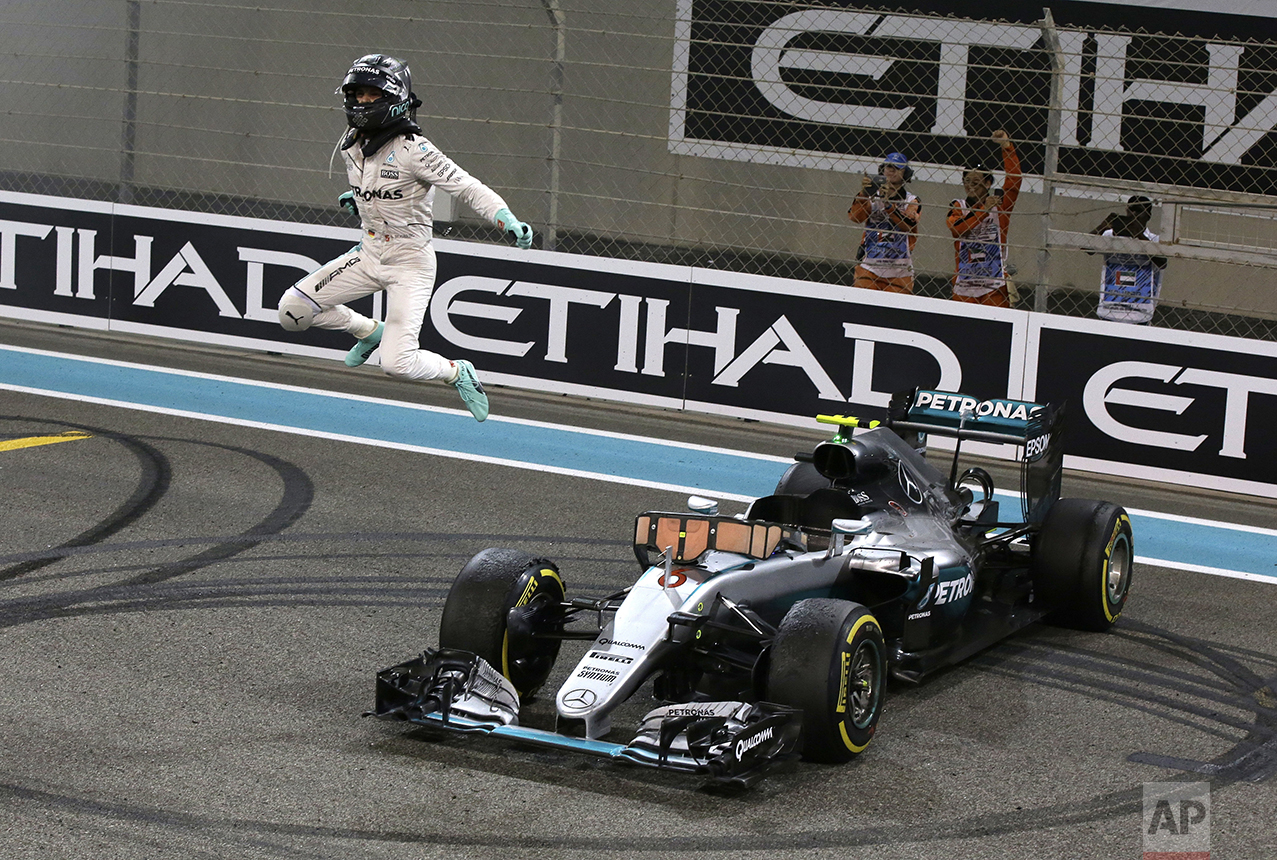  Mercedes driver Nico Rosberg of Germany celebrates after finishing second to win the 2016 world championship during the Emirates Formula One Grand Prix at the Yas Marina racetrack in Abu Dhabi, United Arab Emirates, on Nov. 27, 2016. (AP Photo/Luca 