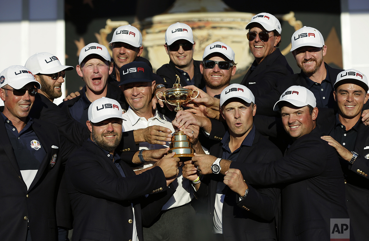  United States captain Davis Love III is surrounded by his players as they pose for a picture during the closing ceremony of the Ryder Cup golf tournament on Oct. 2, 2016, at Hazeltine National Golf Club in Chaska, Minn. (AP Photo/David J. Phillip) 