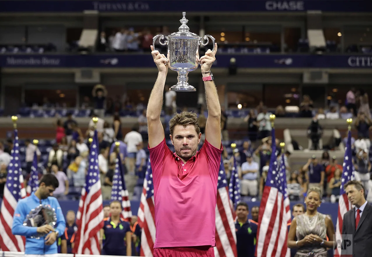 Stan Wawrinka, of Switzerland, holds up the championship trophy after beating Novak Djokovic, of Serbia, to win the men's singles final of the U.S. Open tennis tournament on Sept. 11, 2016, in New York. (AP Photo/Darron Cummings)