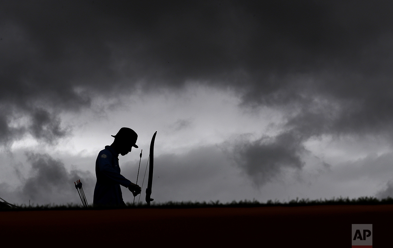  Taiwan's Guan-lin is silhouetted as he prepares to shoot during an elimination round of the individual archery competition at the Sambadrome venue during the 2016 Summer Olympics in Rio de Janeiro, Brazil, on Aug. 10, 2016. (AP Photo/Alessandra Tara