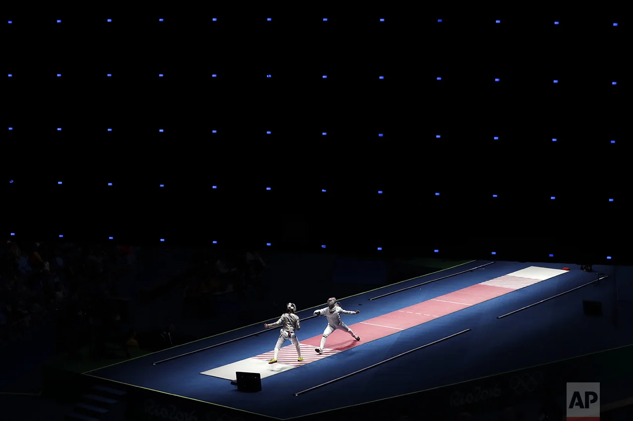 Anna Marton of Hungary, right, fences against Manon Brunet of France during women's saber individual fencing competition in the 2016 Summer Olympics in Rio de Janeiro on Aug. 8, 2016. (AP Photo/Gregory Bull)