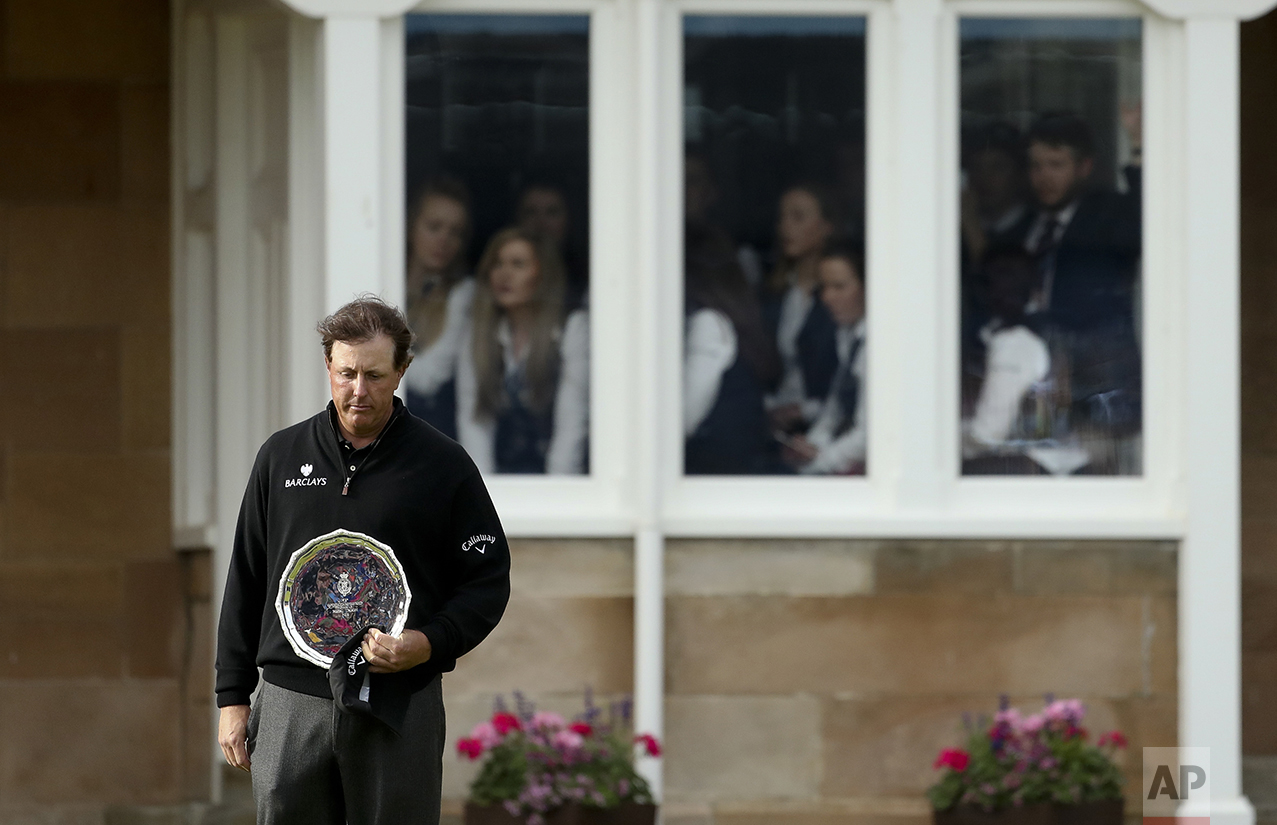  Phil Mickelson of the United States looks down as he holds the silver plate, for being runner up in the British Open Golf Championships at the Royal Troon Golf Club in Troon, Scotland, on July 17, 2016. Henrik Stenson won the Championship. (AP Photo