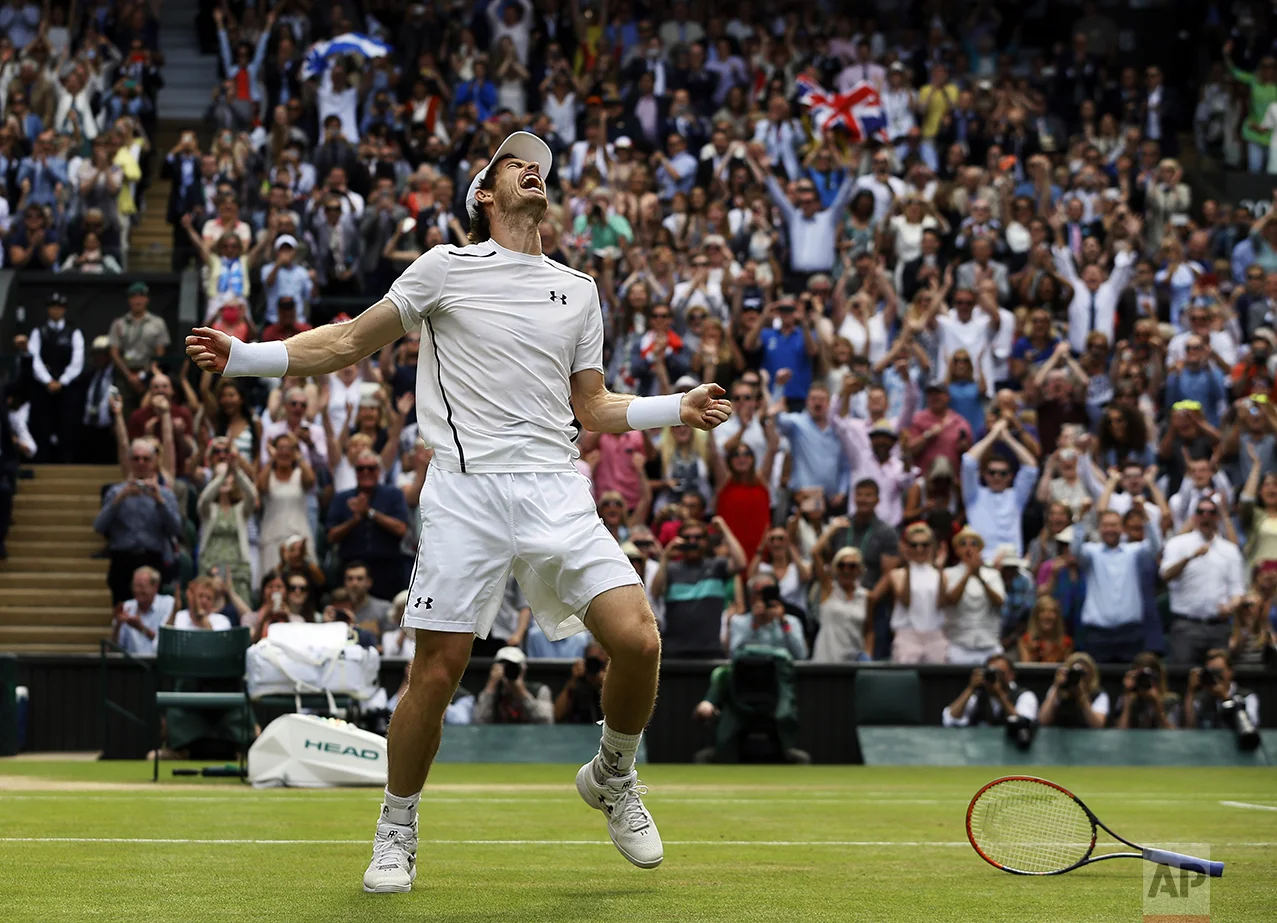 Andy Murray of Britain celebrates after beating Milos Raonic of Canada in the men's singles final on the fourteenth day of the Wimbledon Tennis Championships in London on July 10, 2016. (AP Photo/Kirsty Wigglesworth)