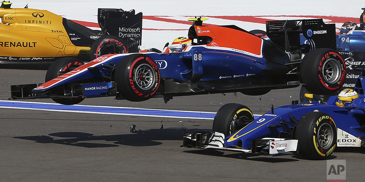  Manor driver Rio Haryanto of Indonesia flies over Sauber driver Marcus Ericsson of Sweden during an accident at the start of the Formula One Russian Grand Prix at the Sochi Autodrom racetrack in Sochi, Russia, on May 1, 2016.(AP Photo/Denis Tyrin) 