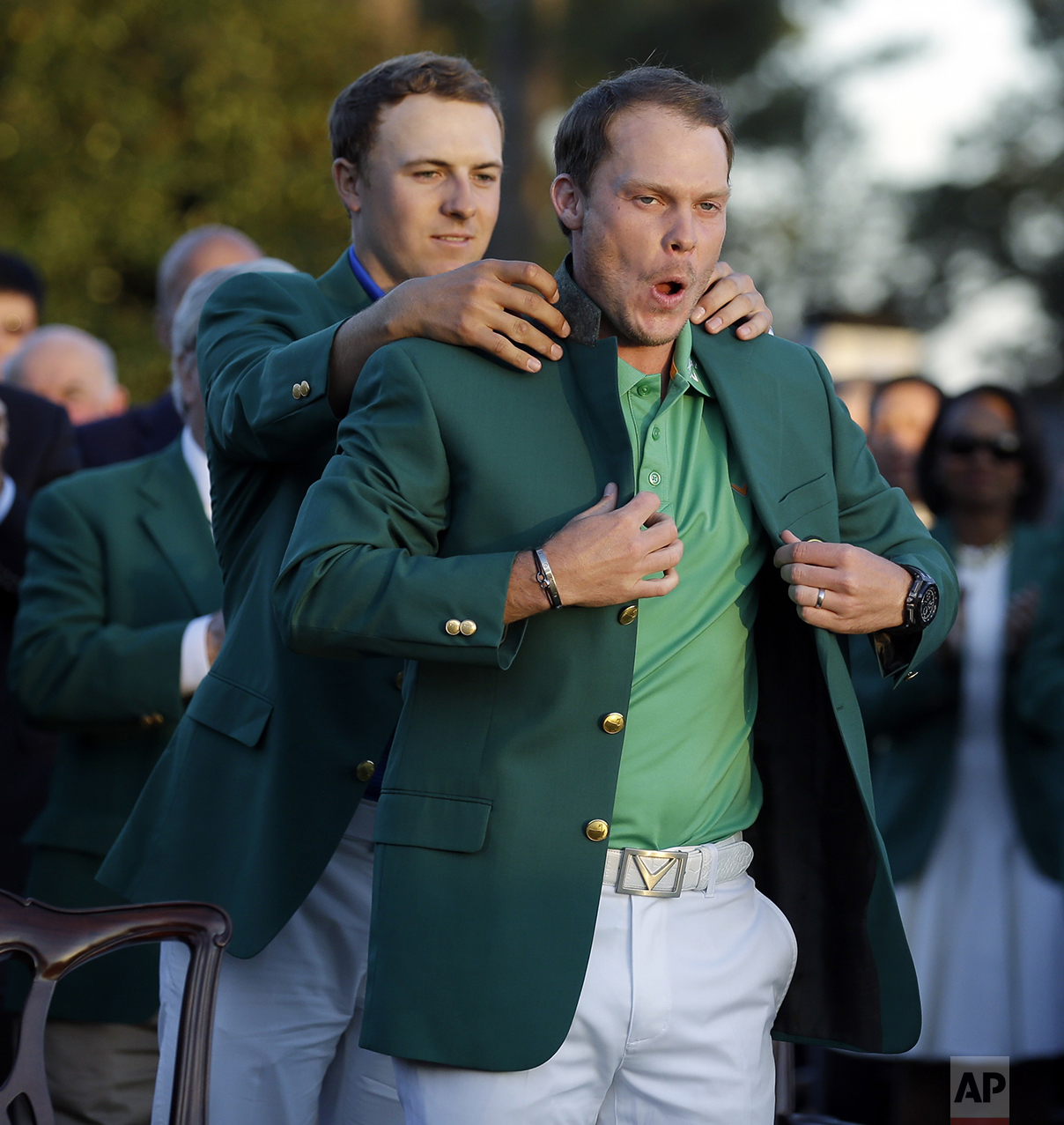  Defending champion Jordan Spieth, left, helps 2016 Masters champion Danny Willett, of England, put on his green jacket following the final round of the Masters golf tournament on April 10, 2016, in Augusta, Ga. (AP Photo/Chris Carlson) 