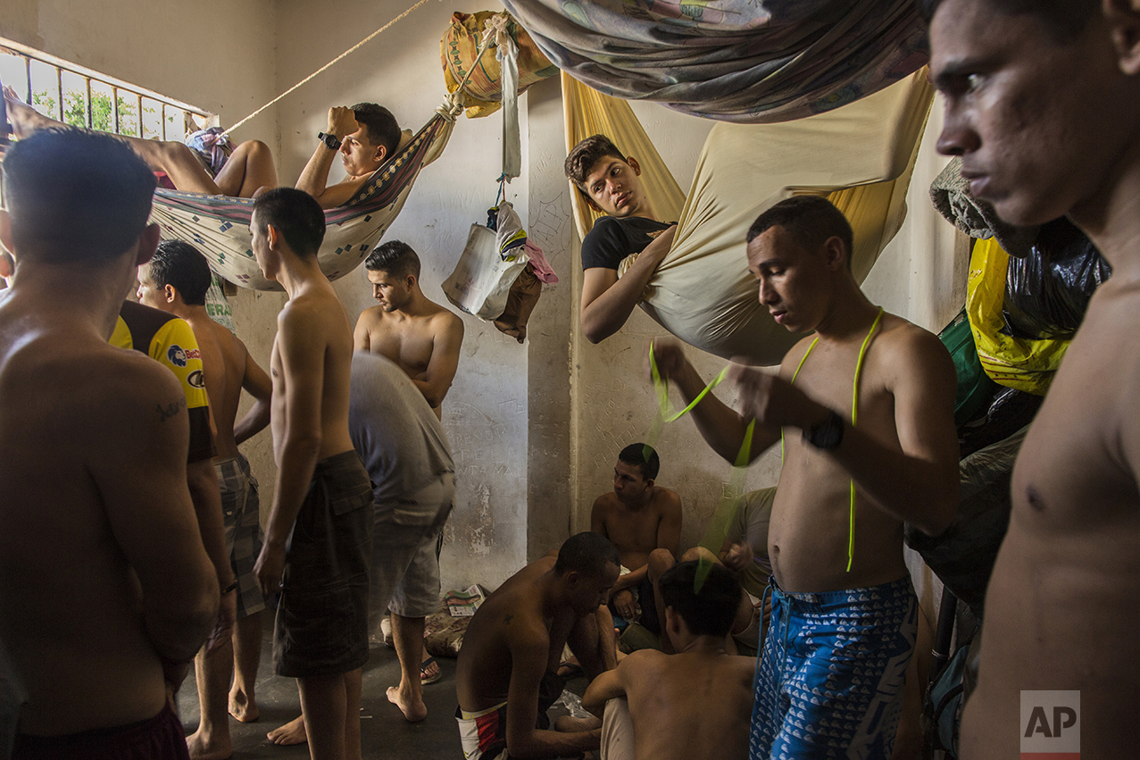 In this Nov. 7, 2016 photo, suspects of violent crime crowd a holding cell at the municipal police station in Cumana, Sucre state, Venezuela. Police are reluctant to make mass arrests of pirates robbing and killing fishermen at sea because the jails are already packed full, with prisoners sleeping in shifts at night. (AP Photo/Rodrigo Abd)