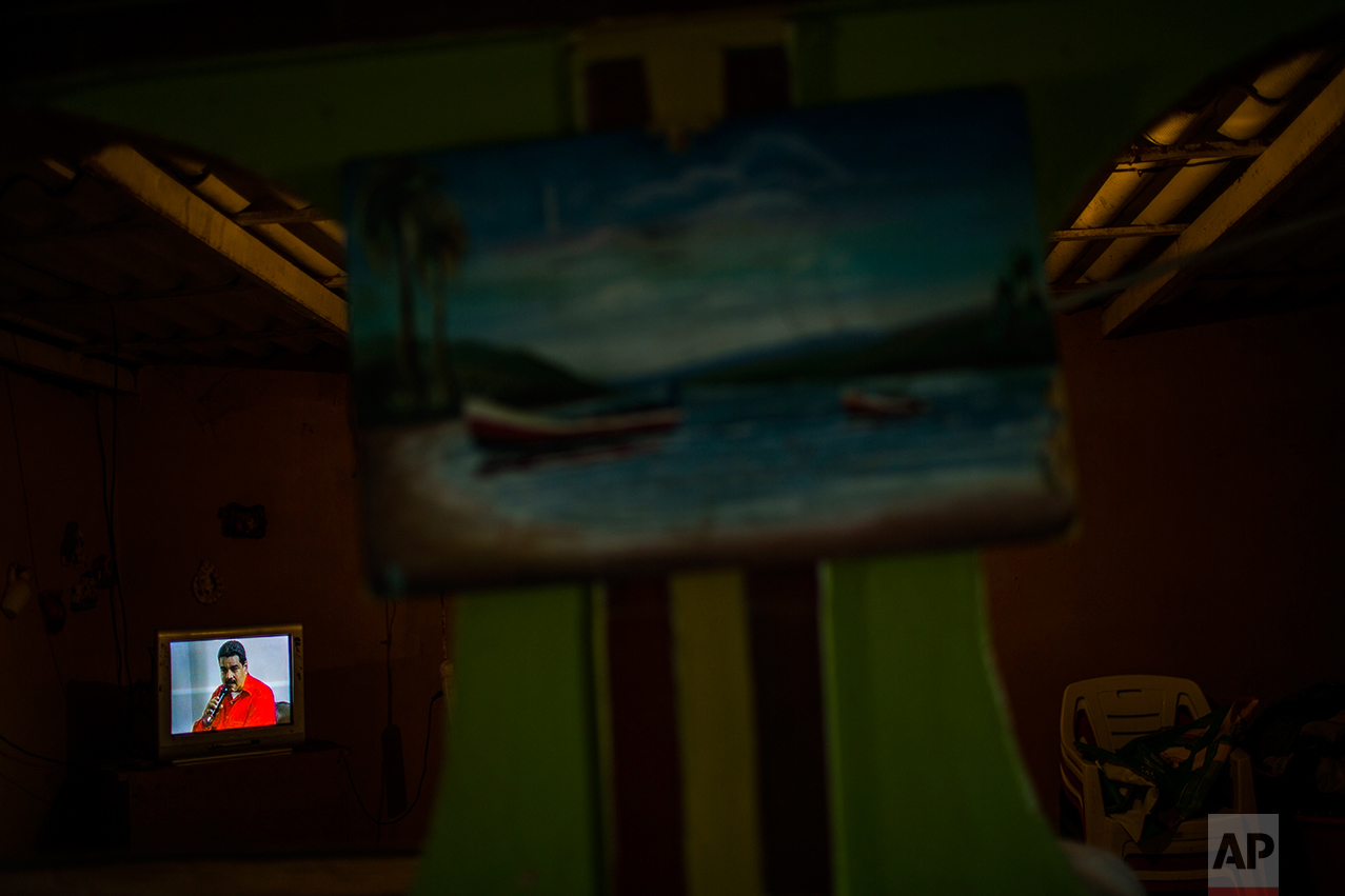 This Nov. 10, 2016 photo shows a televised program airing Venezuela's President Nicolas Maduro speaking, in Punta de Araya, Sucre state, Venezuela. Sucre was once a bastion of support for the ruling socialist party, but that support has eroded as the economy has crumbled. (AP Photo/Rodrigo Abd)