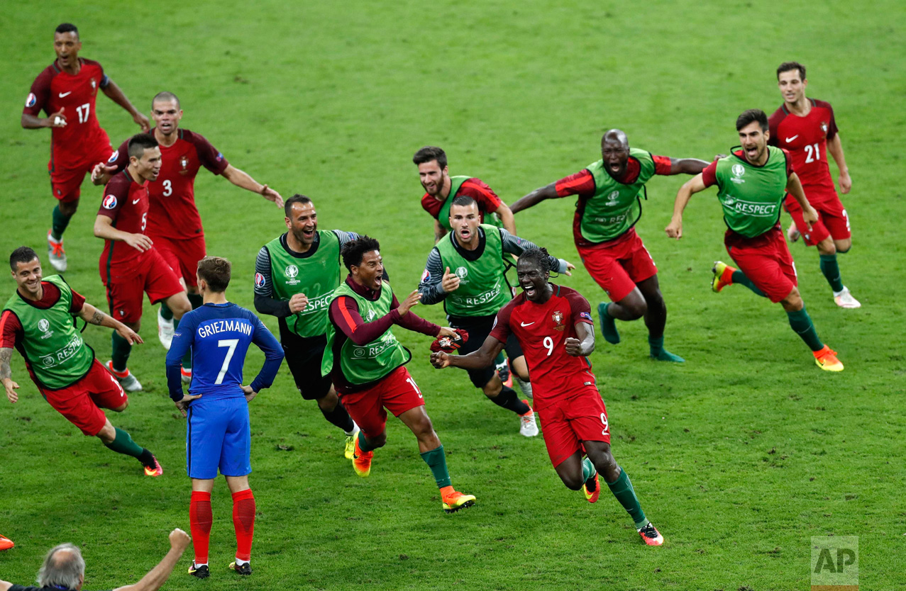  In this Sunday, July 10, 2016 photo, Portugal's Eder, front right, celebrates after scoring the opening goal during the Euro 2016 final soccer match between Portugal and France at the Stade de France in Saint-Denis, north of Paris. (AP Photo/Michael